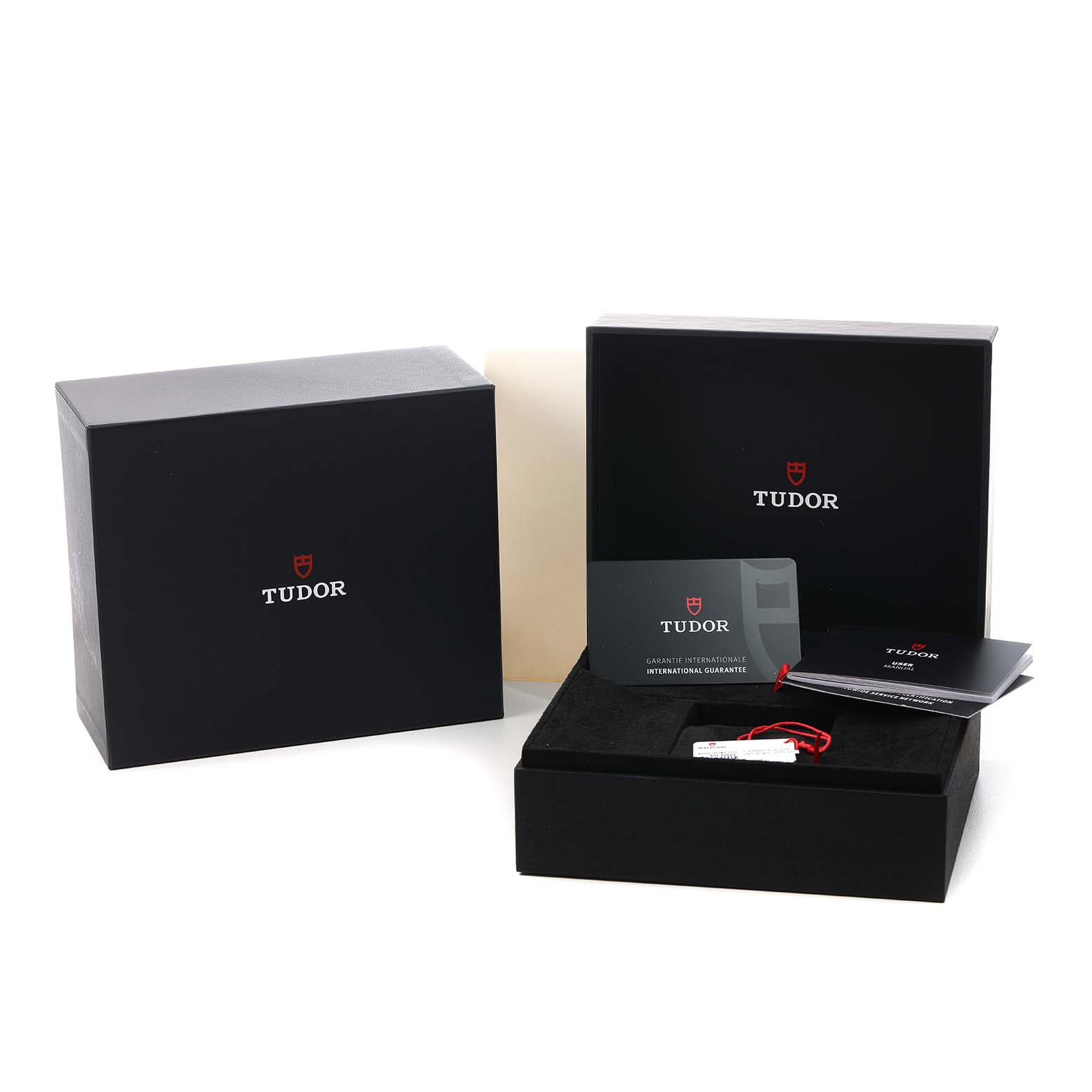 The image shows the packaging and accessories for the Tudor Pelagos 2542G257 Men's Titanium Black Dial watch, including boxes, a tag, and a warranty card.