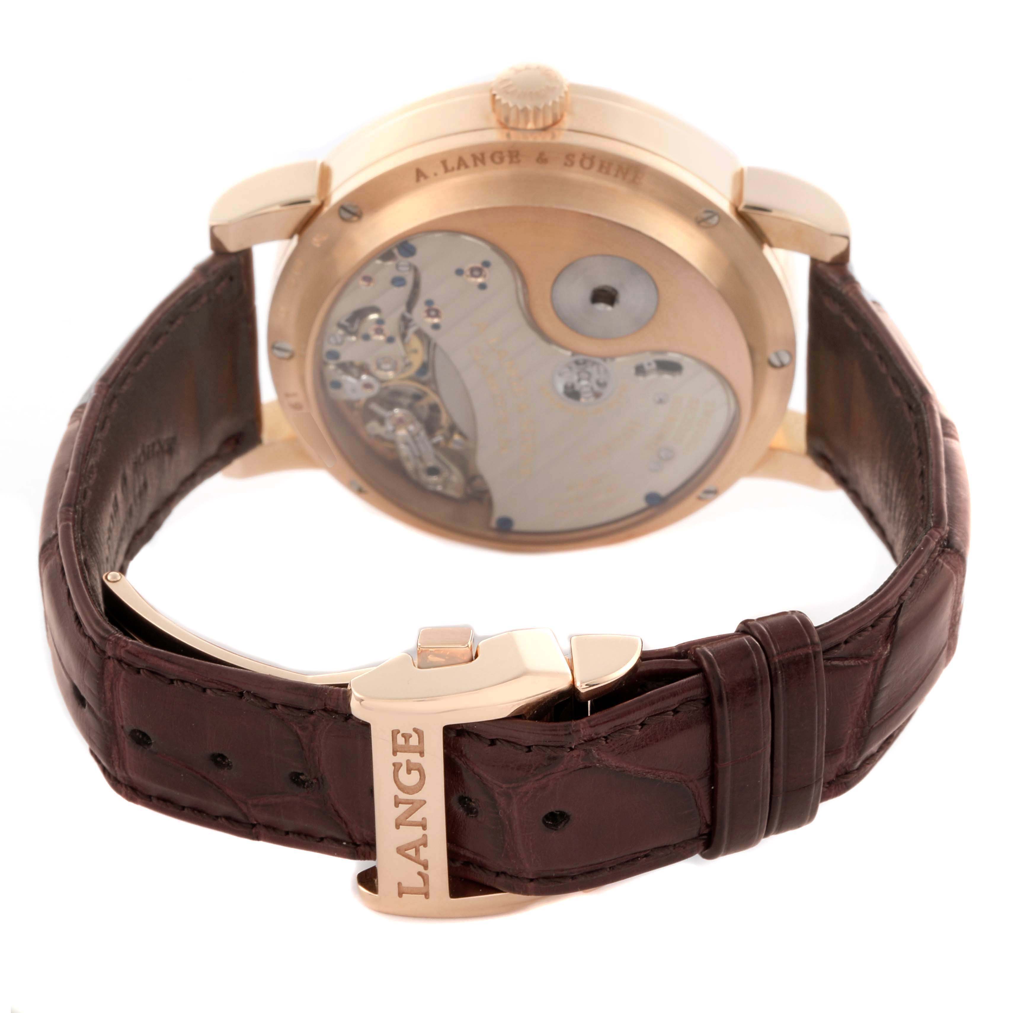 The image shows the back view of a Lange 1 by A. Lange & Söhne, highlighting the movement through the caseback and the leather strap with a branded clasp.