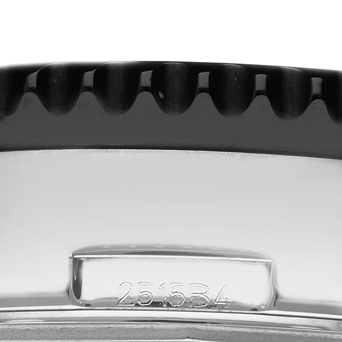 This image shows a close-up of the side of a Breitling Chronoliner Y2431012/BE10 Men's Stainless Steel Black Dial Y2431012/BE10 Men's Stainless Steel Black Dial watch, featuring the bezel and part of the case with the serial number.