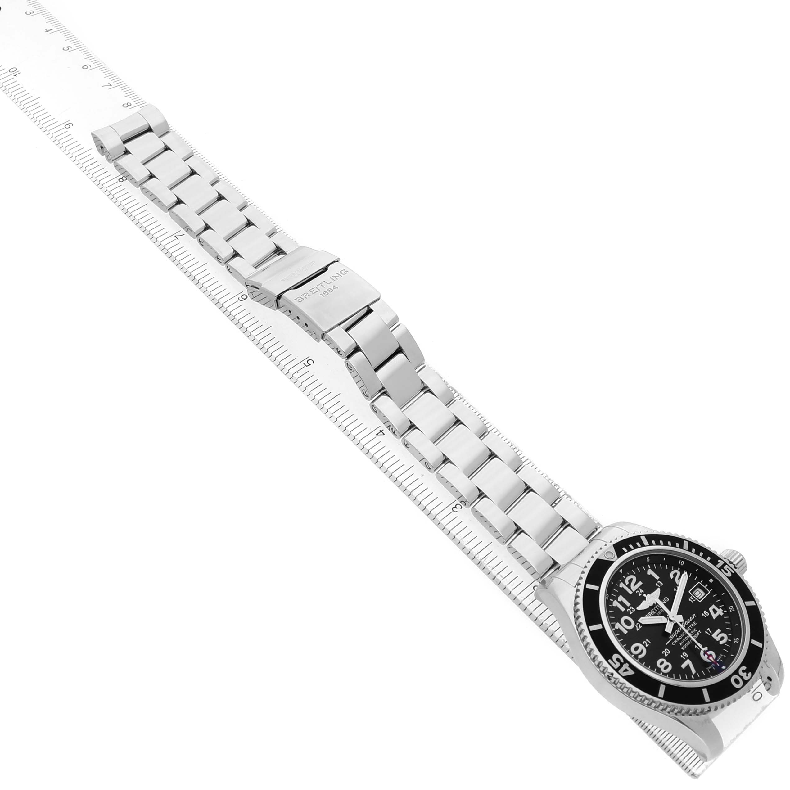 The Breitling Superocean A17365 Men's Stainless Steel Black Dial watch is shown from an angled top view, displaying the entire band, clasp, and watch face.