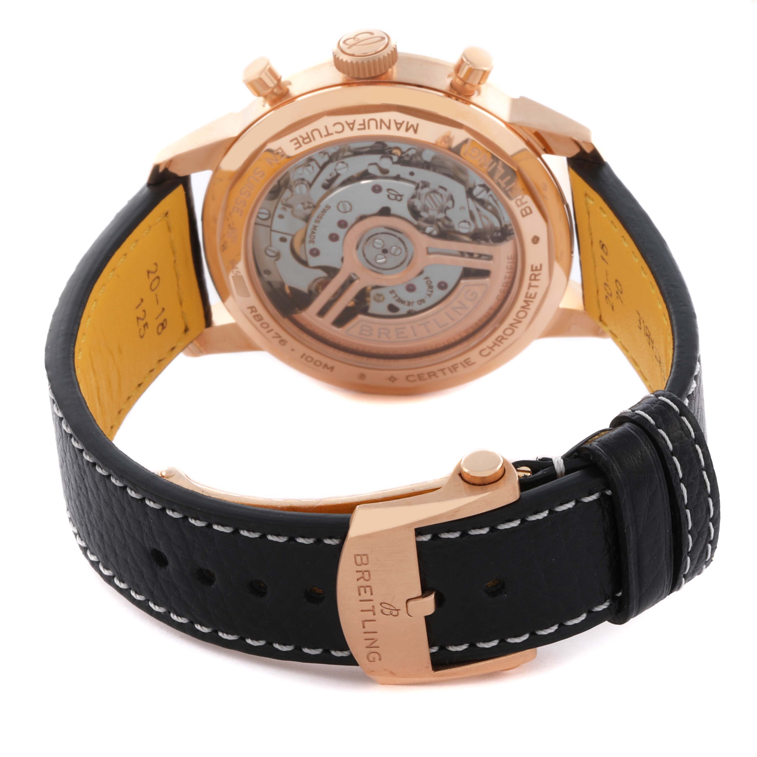 The Breitling Premier RB01761A1Q1X1 Men's Rose Gold Brown Dial RB01761A1Q1X1 Men's Rose Gold Brown Dial watch is shown from the back, highlighting its caseback, movement, and leather strap with buckle.