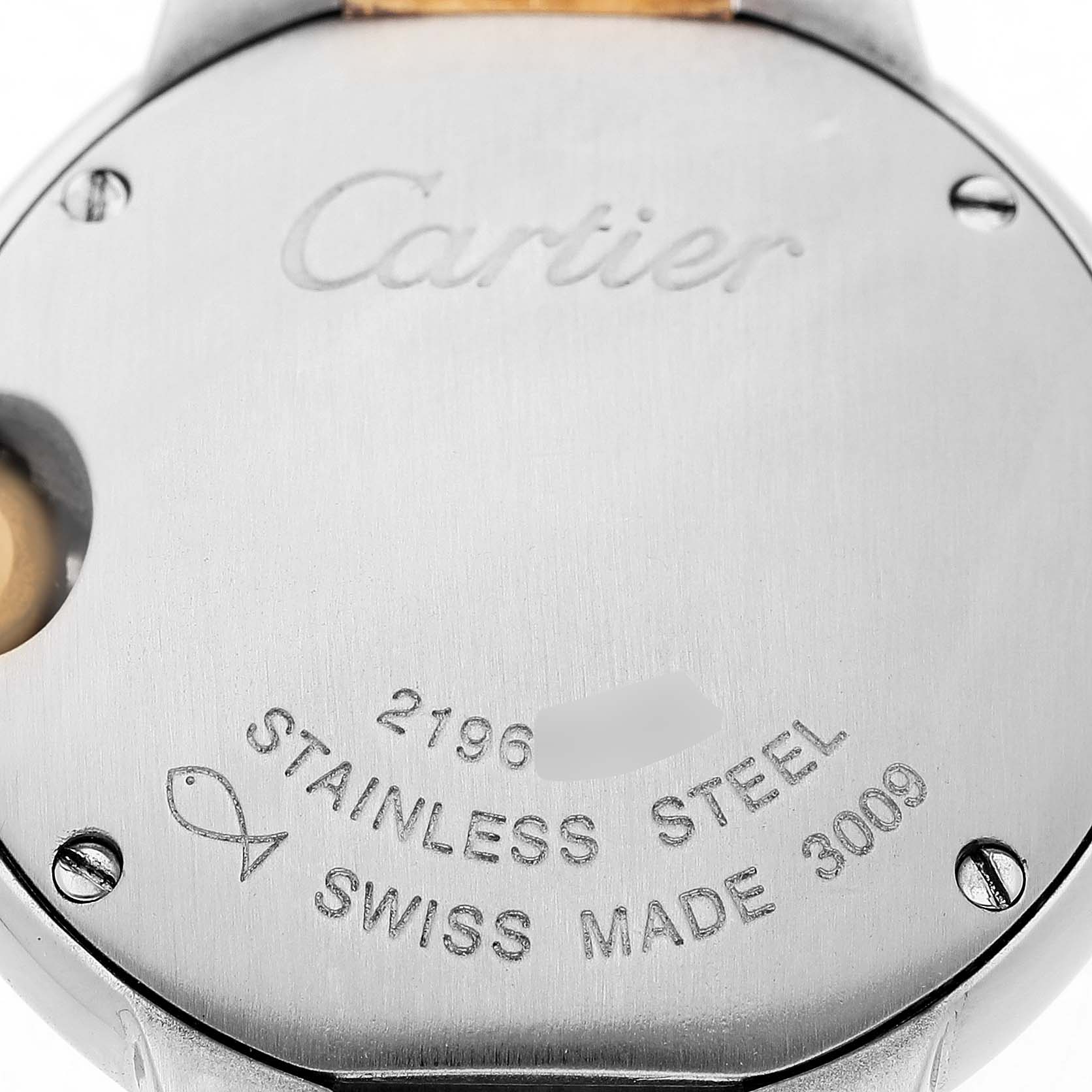 The image shows the back case of a Cartier Ballon Bleu W69007Z3 Women's Steel and Gold (two tone) Silver Dial watch, featuring engraved details and screws.