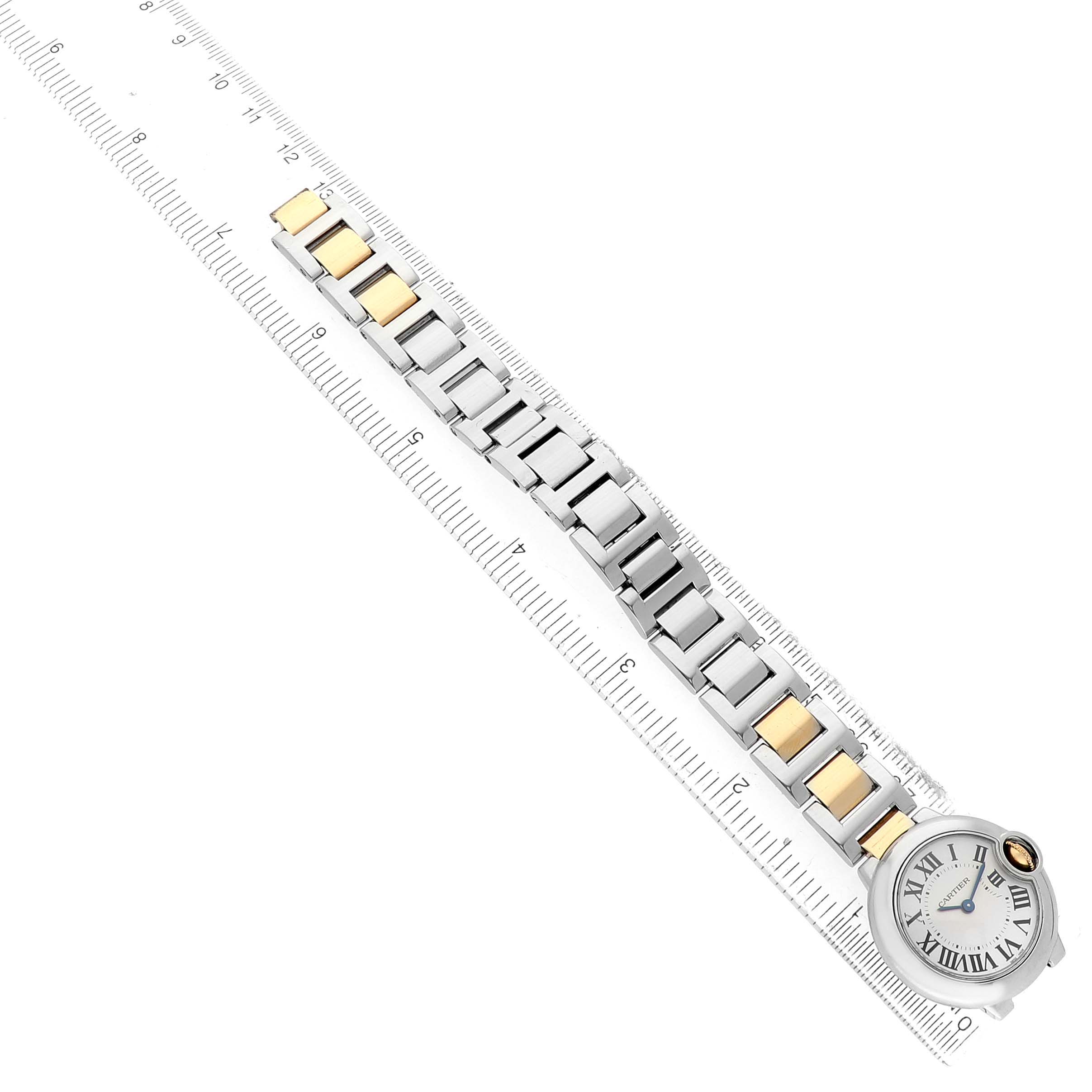 The Cartier Ballon Bleu W69007Z3 Women's Steel and Gold (two tone) Silver Dial watch is shown from an overhead angle, displaying its bracelet and face, alongside a ruler for scale.