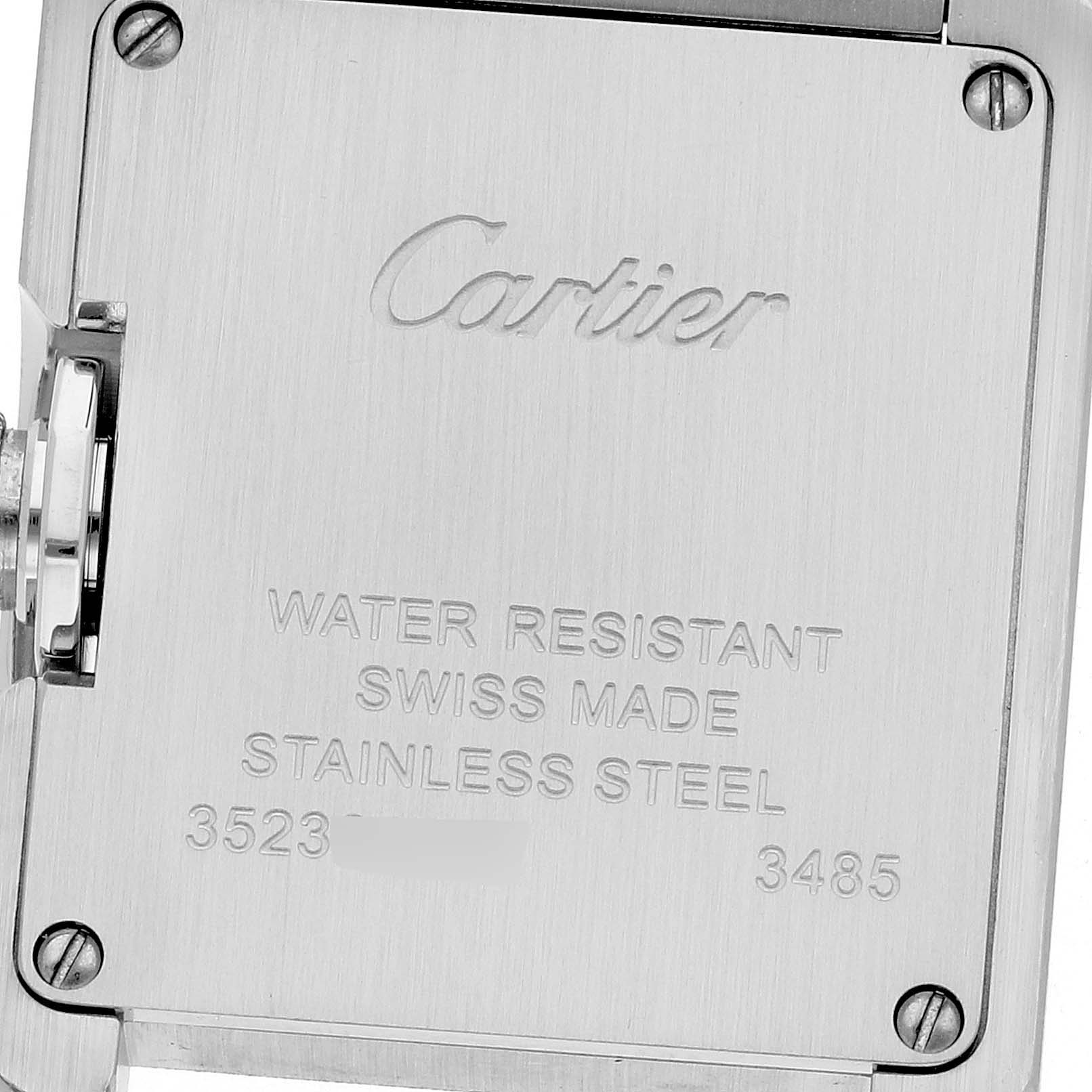 The image shows the back case of a Cartier Tank Anglaise W5310022 Women
s Stainless Steel Silver Dial W5310022 Women
s Stainless Steel Silver Dial watch, highlighting its engravings and screws.