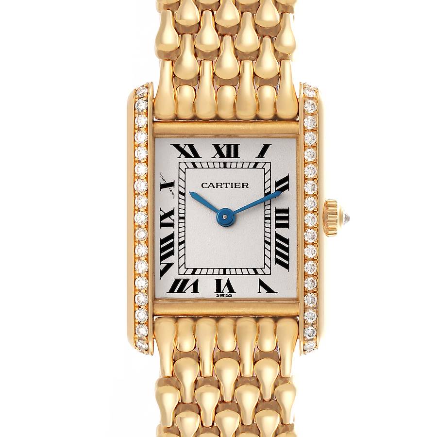 The Cartier Tank Louis watch is shown from a front angle, highlighting its rectangular face and gold bracelet.