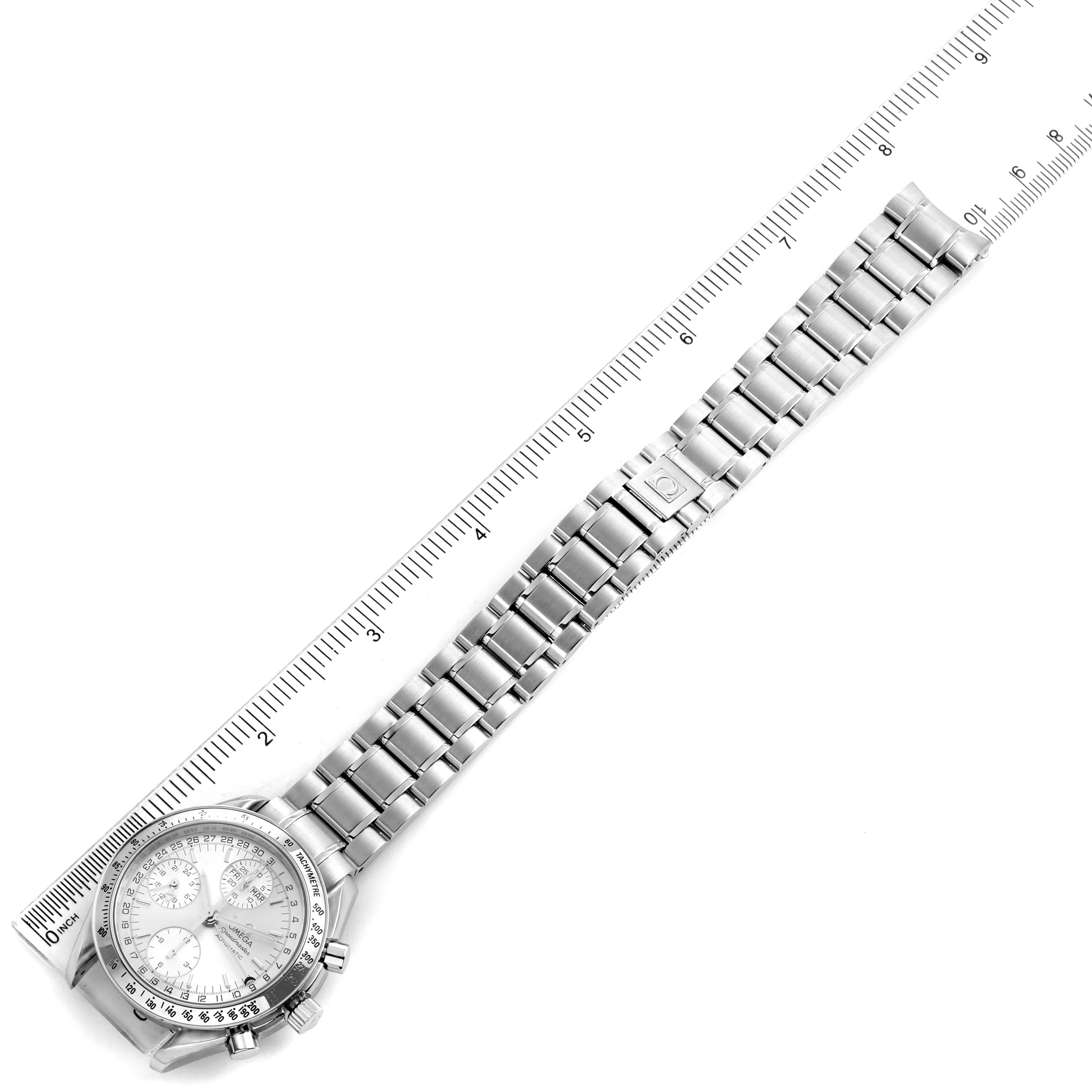 The image shows an overhead view of an Omega Speedmaster 3523.30.00 Men
s Stainless Steel Silver Dial 3523.30.00 Men
s Stainless Steel Silver Dial watch and its metal bracelet placed alongside a measuring ruler.