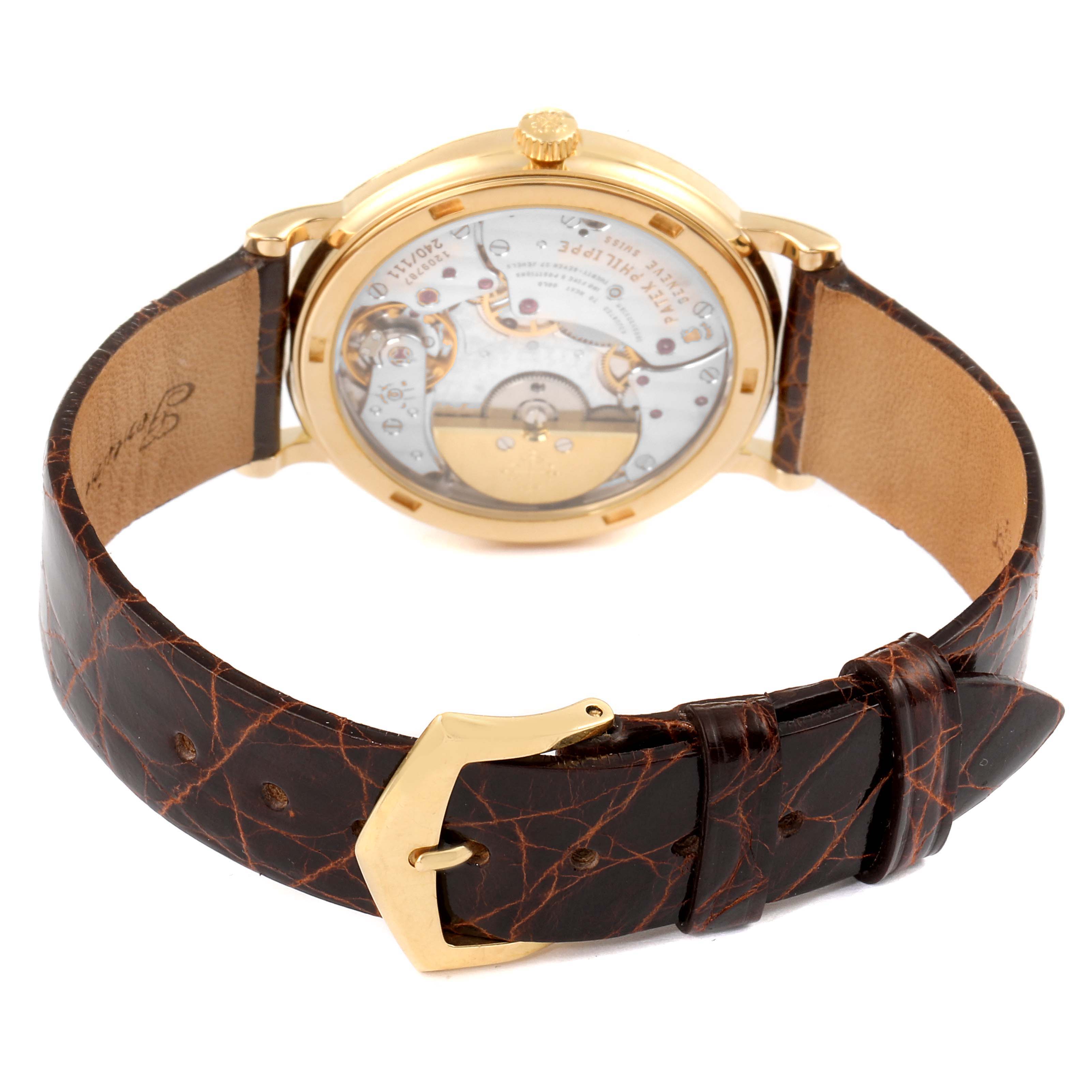 This image shows the back view of the Patek Philippe Calatrava 5120J Men's Yellow Gold White Dial 5120J Men's Yellow Gold White Dial watch, highlighting its transparent case back and leather strap with buckle.