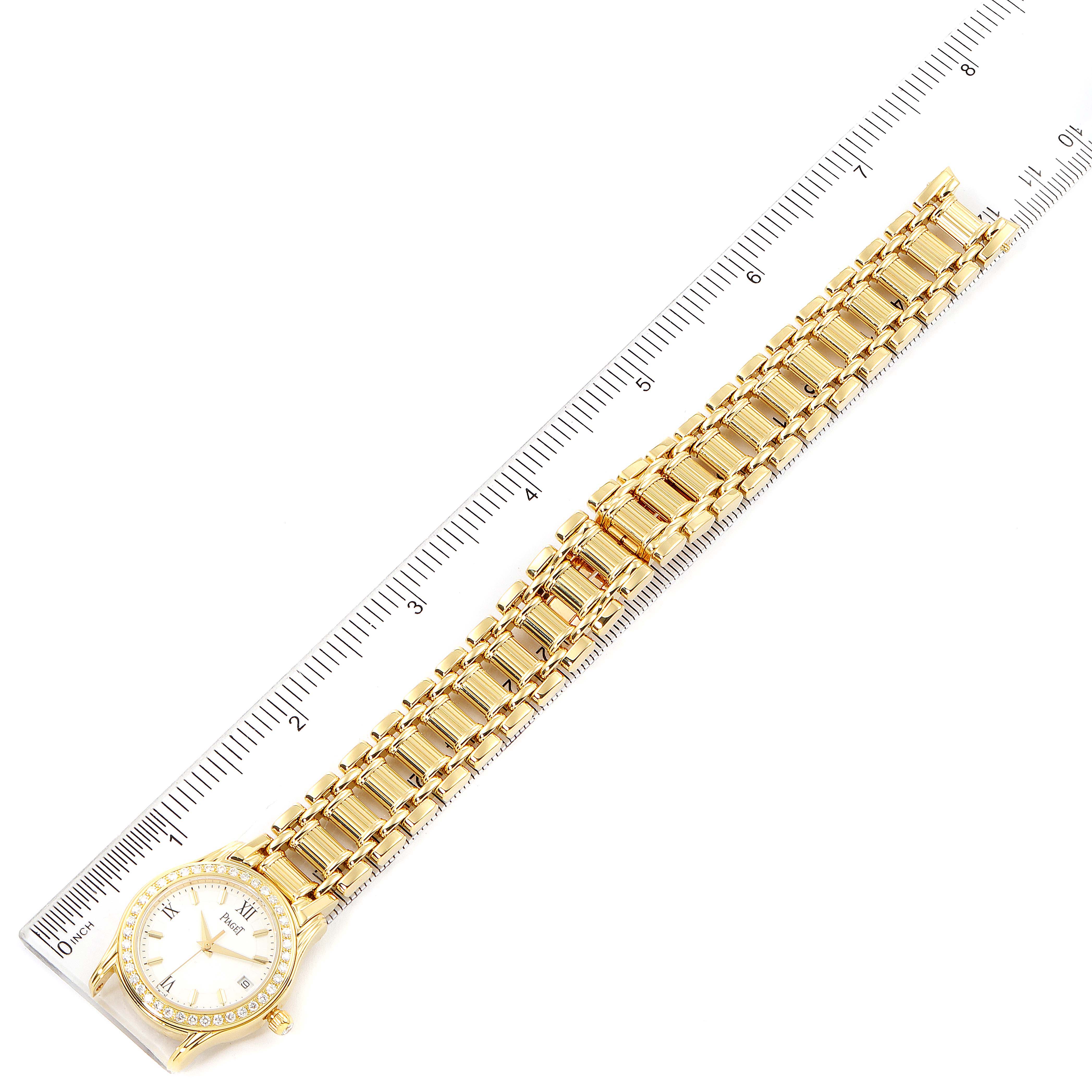 The image shows the Piaget 22005 Women's Yellow Gold White Dial 22005 Women's Yellow Gold White Dial Polo 18k Yellow Gold White Roman Dial Diamond Ladies Watch 22005 model laid flat with a ruler.