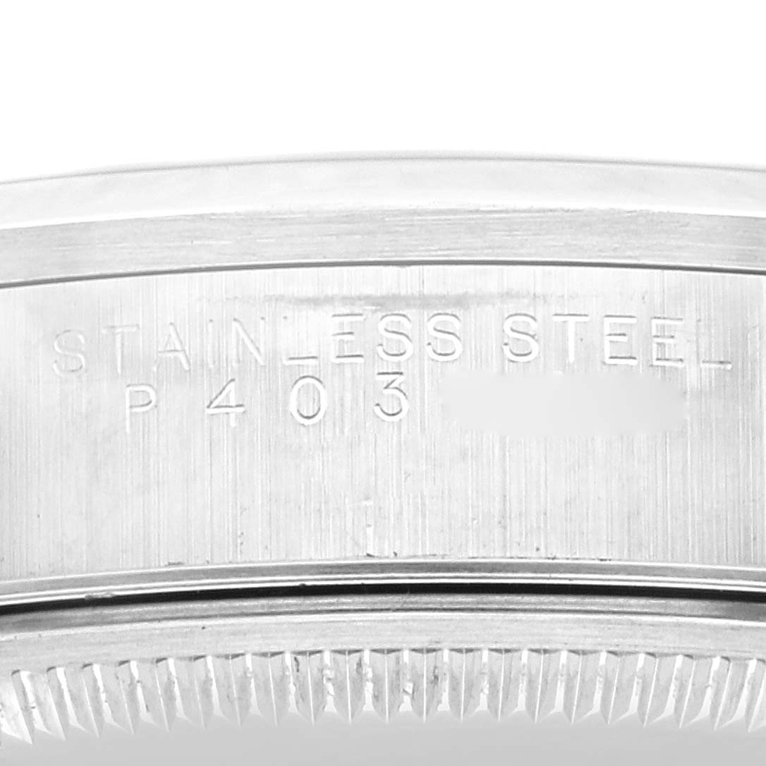 This image shows a close-up of the side of a Rolex Air-King 14000M Men's Stainless Steel Blue Dial 14000M Men's Stainless Steel Blue Dial watch, focusing on the engraved "STAINLESS STEEL" text and markings.