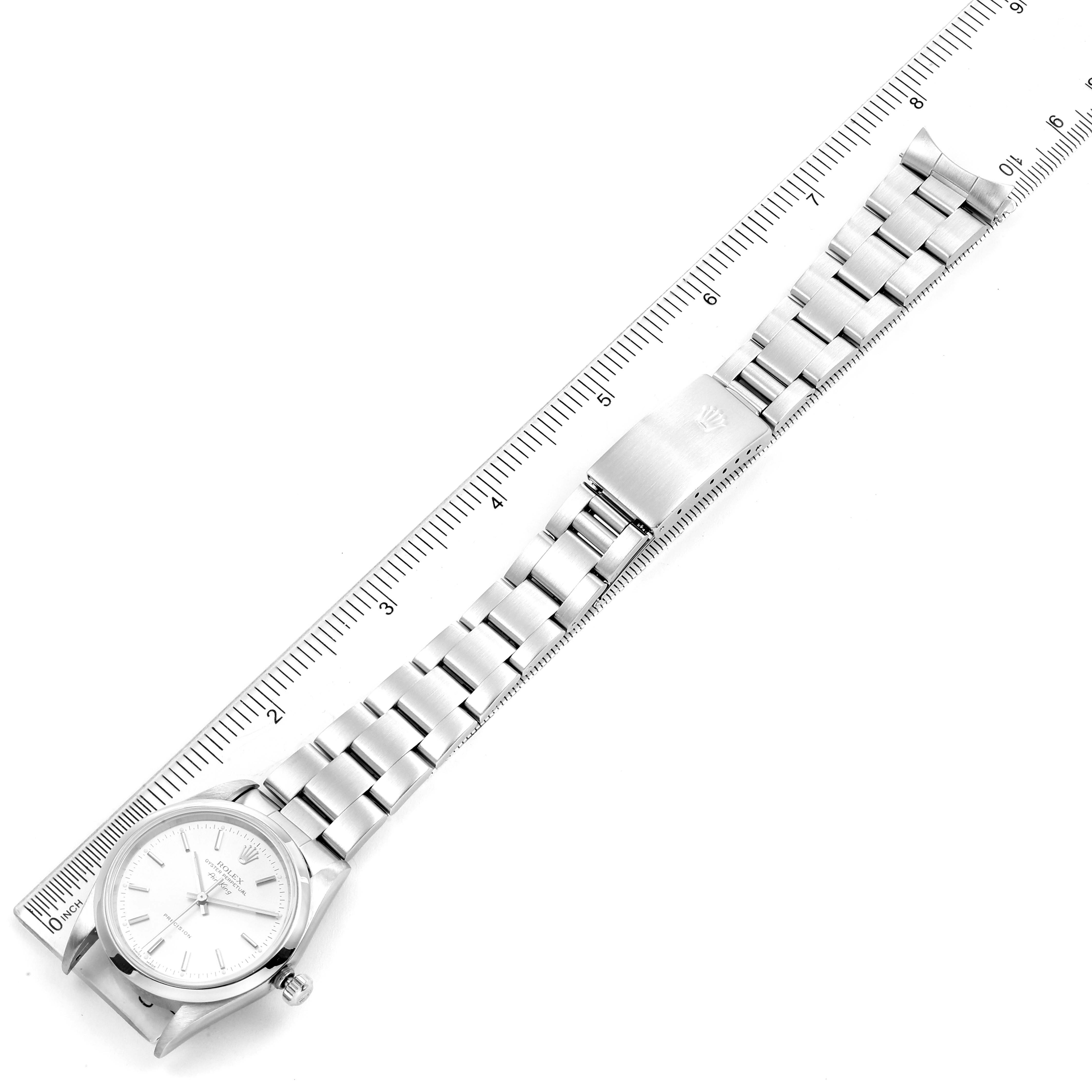 The image shows a top view of a Rolex Air-King 14000 Men's Stainless Steel Silver Dial 14000 Men's Stainless Steel Silver Dial watch, highlighting its dial, bracelet, and clasp, placed next to a ruler.