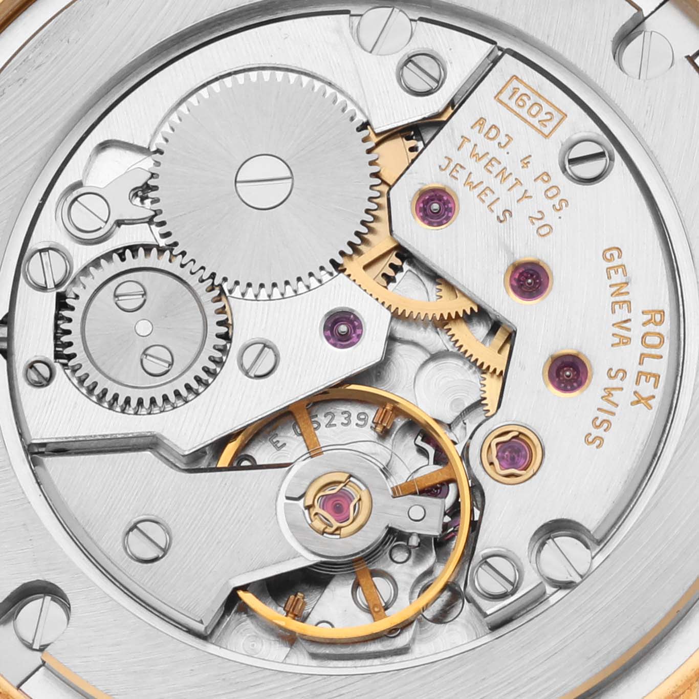 The image shows the intricate movement of a Rolex Cellini 5115 Men's Yellow Gold Grey Dial 5115 Men's Yellow Gold Grey Dial watch, focusing on gears and inscriptions, viewed from the back.
