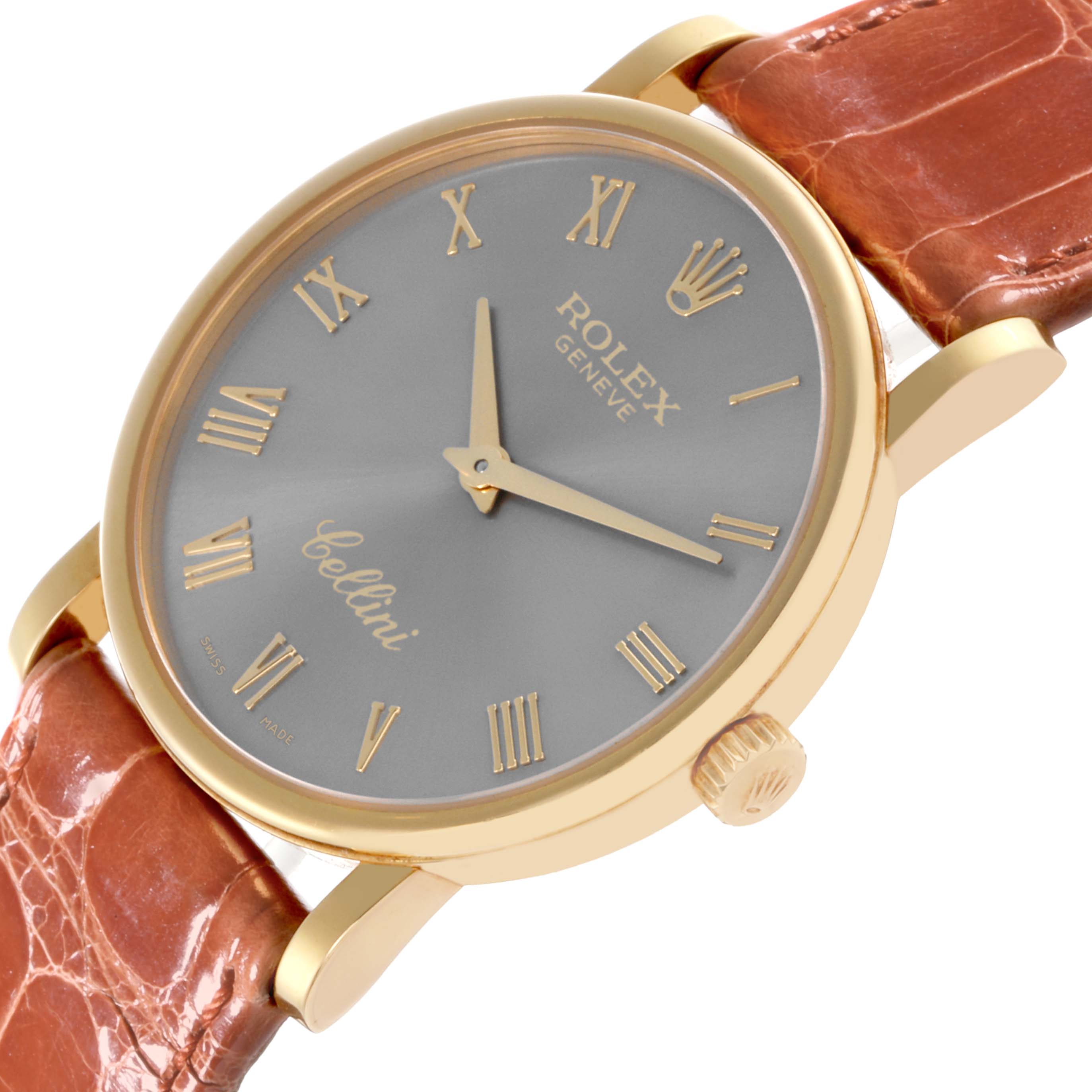 The Rolex Cellini 5115 Men's Yellow Gold Grey Dial 5115 Men's Yellow Gold Grey Dial watch is shown at an angled top view highlighting its face, dial, crown, and leather strap.