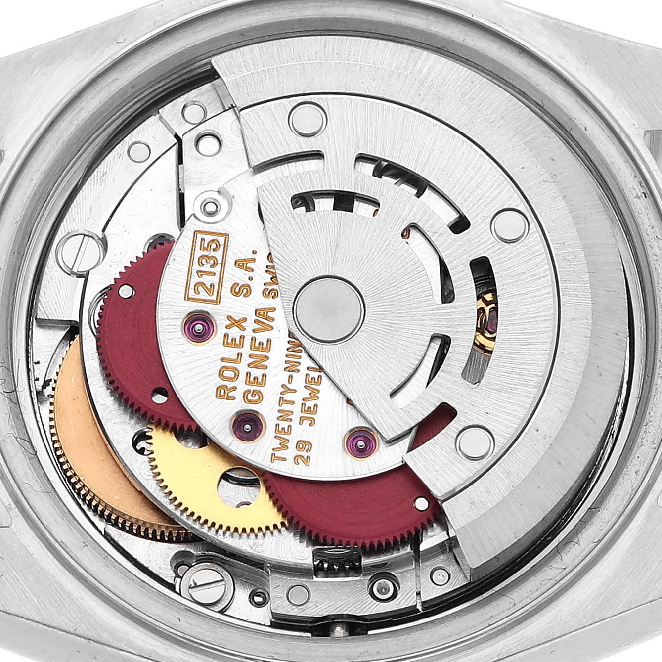The image shows the inner mechanism of the Rolex Datejust 69174 Women's Stainless Steel White Dial, featuring gears and a rotor.