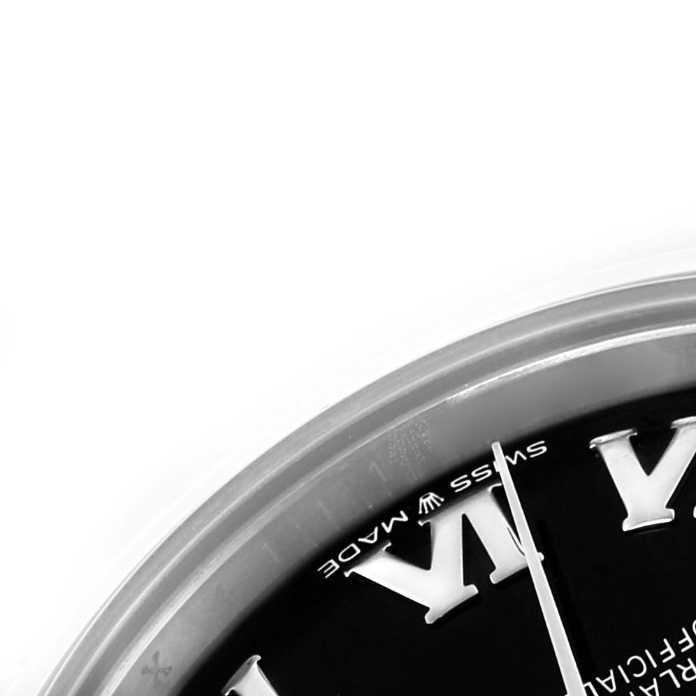 The image shows a close-up angle of a Rolex Datejust, focusing on the edge of the dial and part of the bezel.