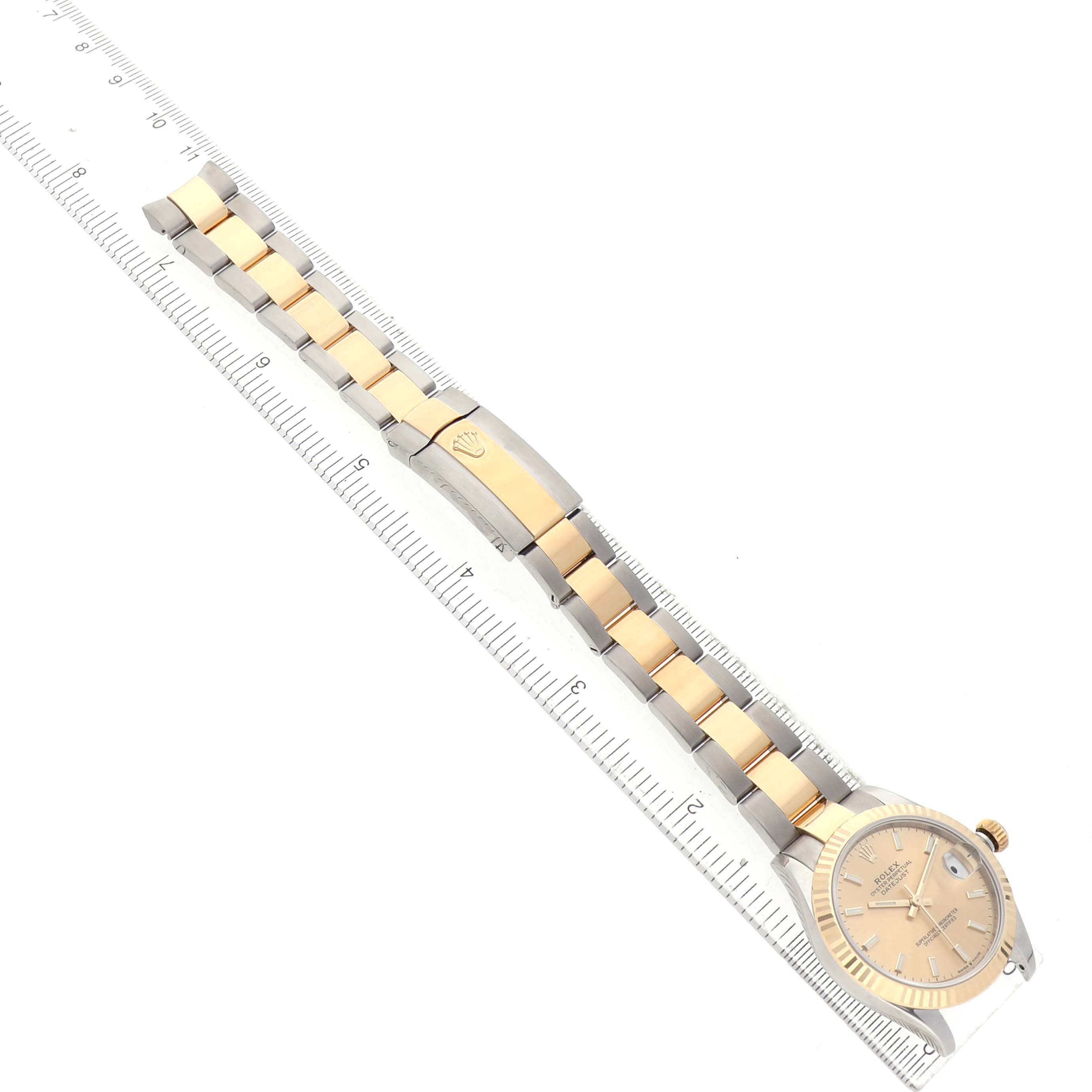 The Rolex Datejust 278273 Women's Steel and Gold (two tone) Champagne Dial watch is shown at an angled top-down view, highlighting the bracelet, clasp, and part of the dial.