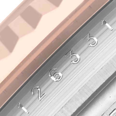 The image shows a close-up of the Rolex Datejust 41 126331 Men's Steel and Gold (two tone) Pink Dial 126331 Men's Steel and Gold (two tone) Pink Dial's fluted bezel and a portion of its numbered date dial.