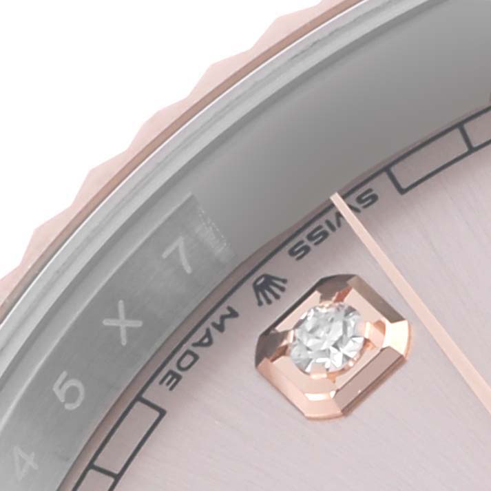 The image shows a partial close-up of the dial and bezel of a Rolex Datejust 41 126331 Men's Steel and Gold (two tone) Pink Dial 126331 Men's Steel and Gold (two tone) Pink Dial watch, featuring a diamond hour marker.