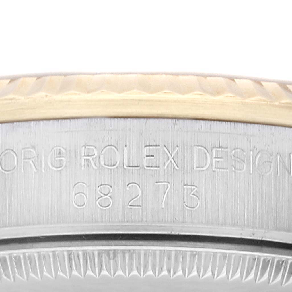 The image shows a close-up of the side of a Rolex Mid-Size 68273G Women's Steel and Gold (two tone) Champagne Dial 68273G Women's Steel and Gold (two tone) Champagne Dial watch, highlighting the model number "68273" engraved on its case.
