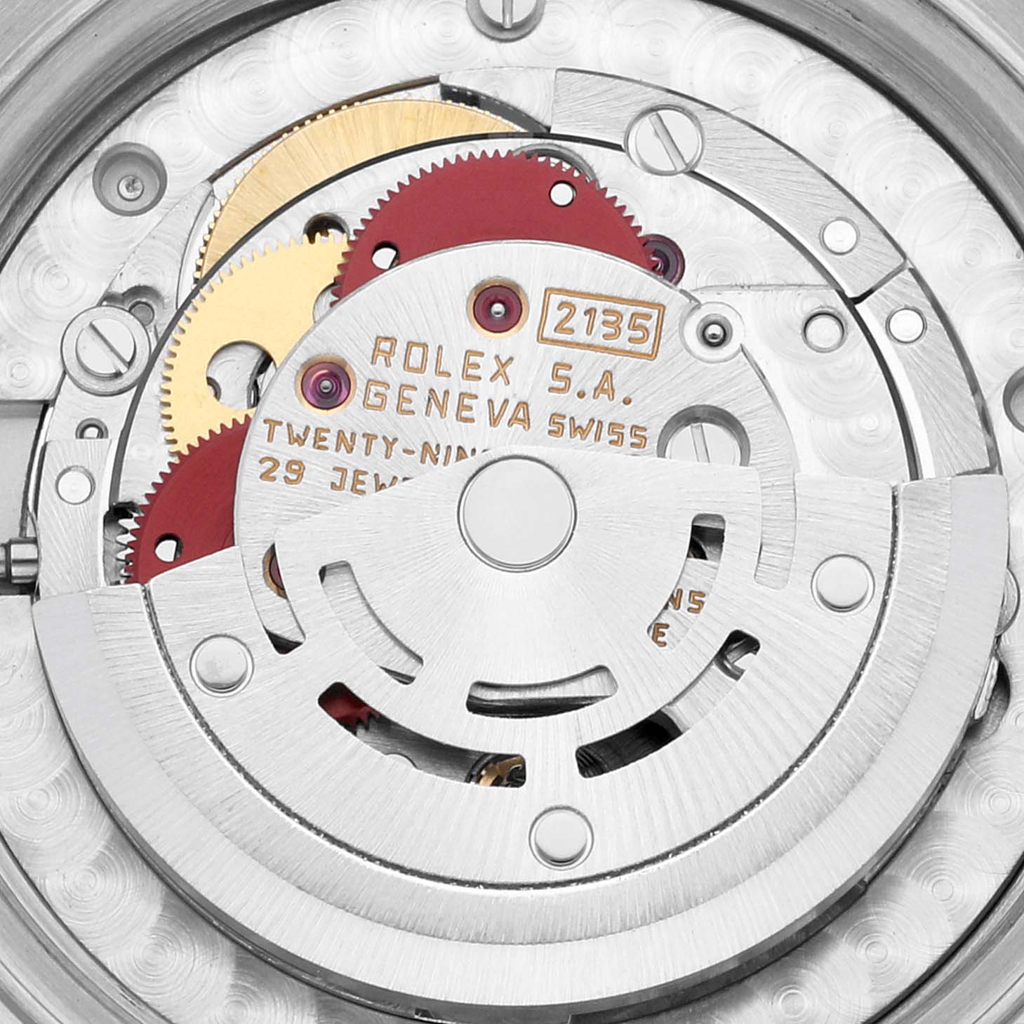 The image shows a close-up view of the internal mechanism of the Rolex Mid-Size 68273G Women's Steel and Gold (two tone) Champagne Dial 68273G Women's Steel and Gold (two tone) Champagne Dial model, showcasing gears and engravings.