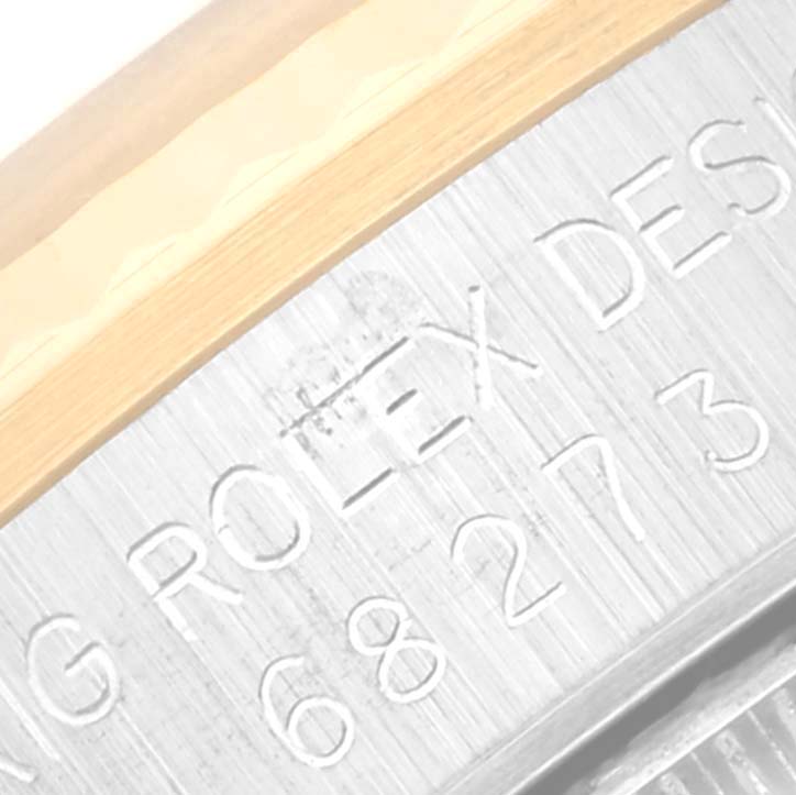 The image shows a close-up of the side engraving on a Mid-Size Rolex watch, highlighting the Rolex branding and part of the model number.