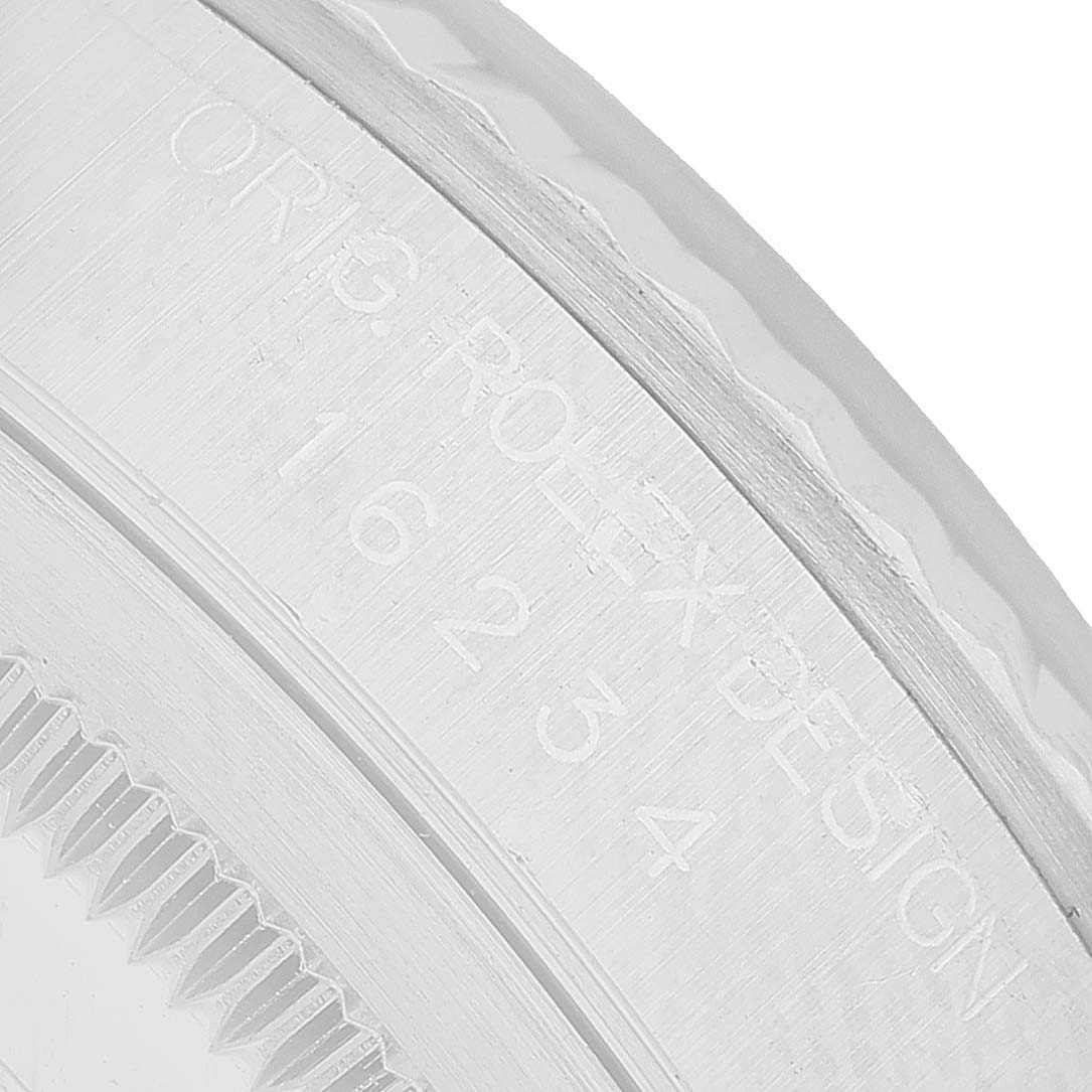 The image shows a close-up of the side and edge of a Rolex Datejust 16234 Men's Stainless Steel Silver Dial watch, focusing on the engraved text and edge detailing.