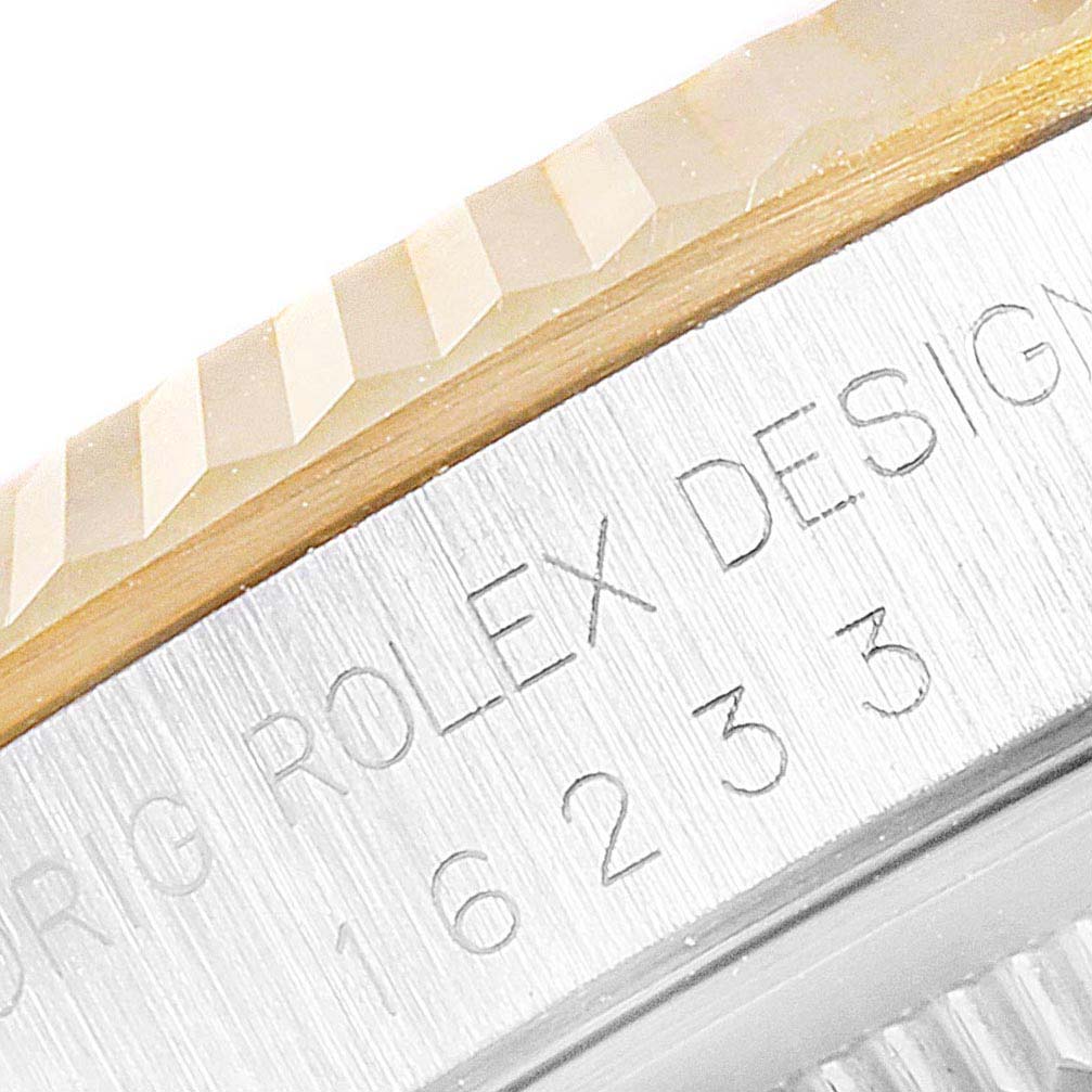 Close-up of the bezel and serial number engraving on a Rolex Datejust 16233 Men's Steel and Gold (two tone) Champagne Dial 16233 Men's Steel and Gold (two tone) Champagne Dial model watch.