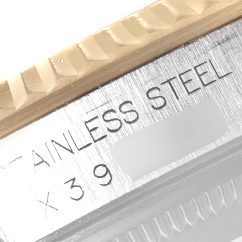 The image shows a close-up of the stainless steel and gold fluted bezel of the Rolex Datejust 16233 Men's Steel and Gold (two tone) Champagne Dial 16233 Men's Steel and Gold (two tone) Champagne Dial watch.