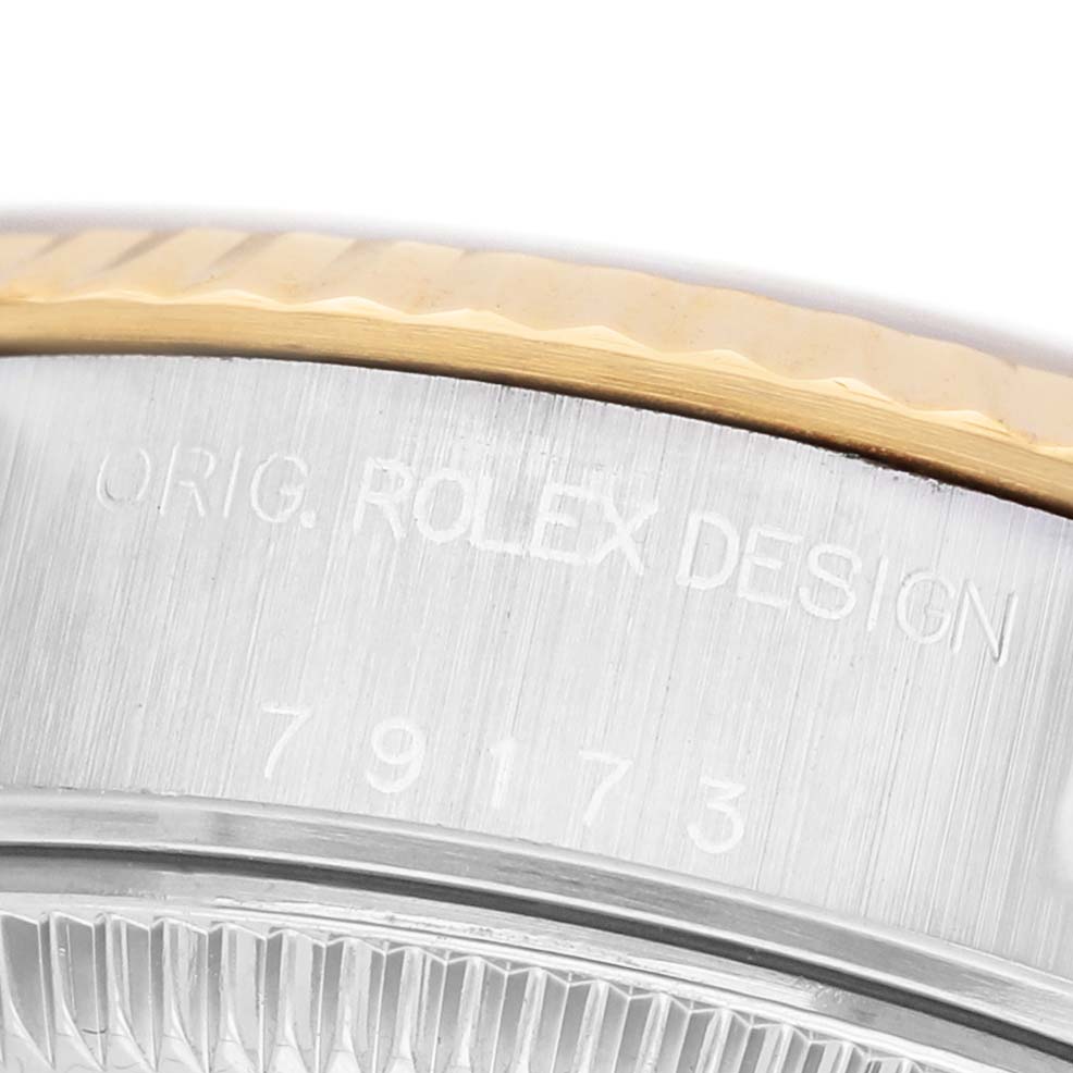 The image shows a close-up of the engraving on the side of a Rolex Datejust 79173 Women's Steel and Gold (two tone) Beige Dial model, highlighting the model number.