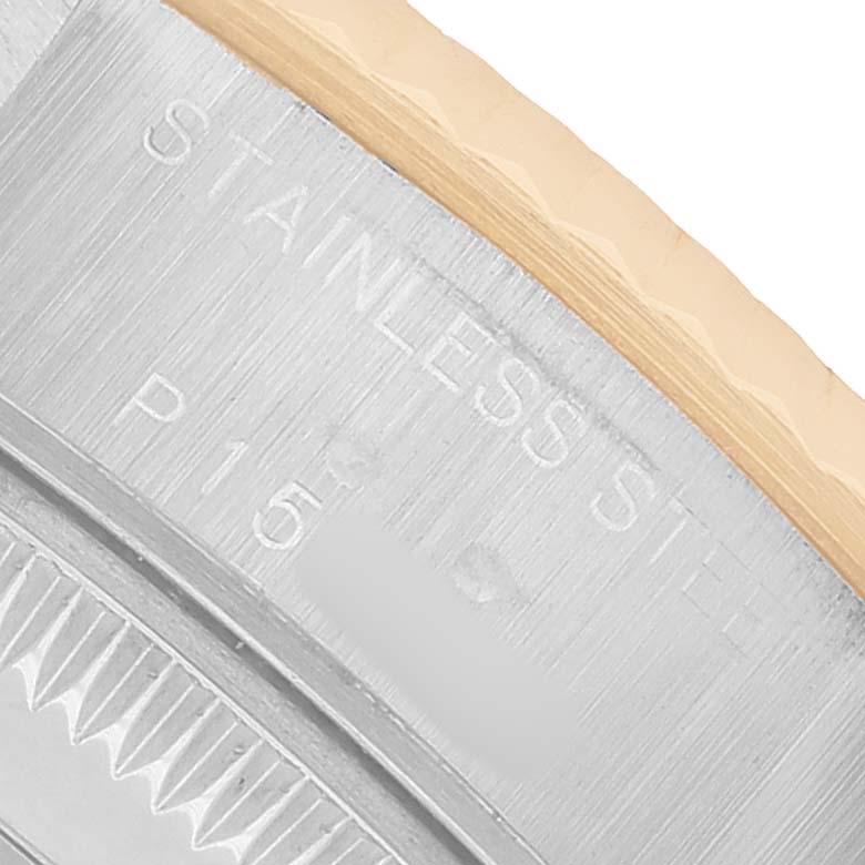 The image shows a close-up of the case edge and engraved details of a Rolex Datejust 79173 Women's Steel and Gold (two tone) Silver Dial watch.