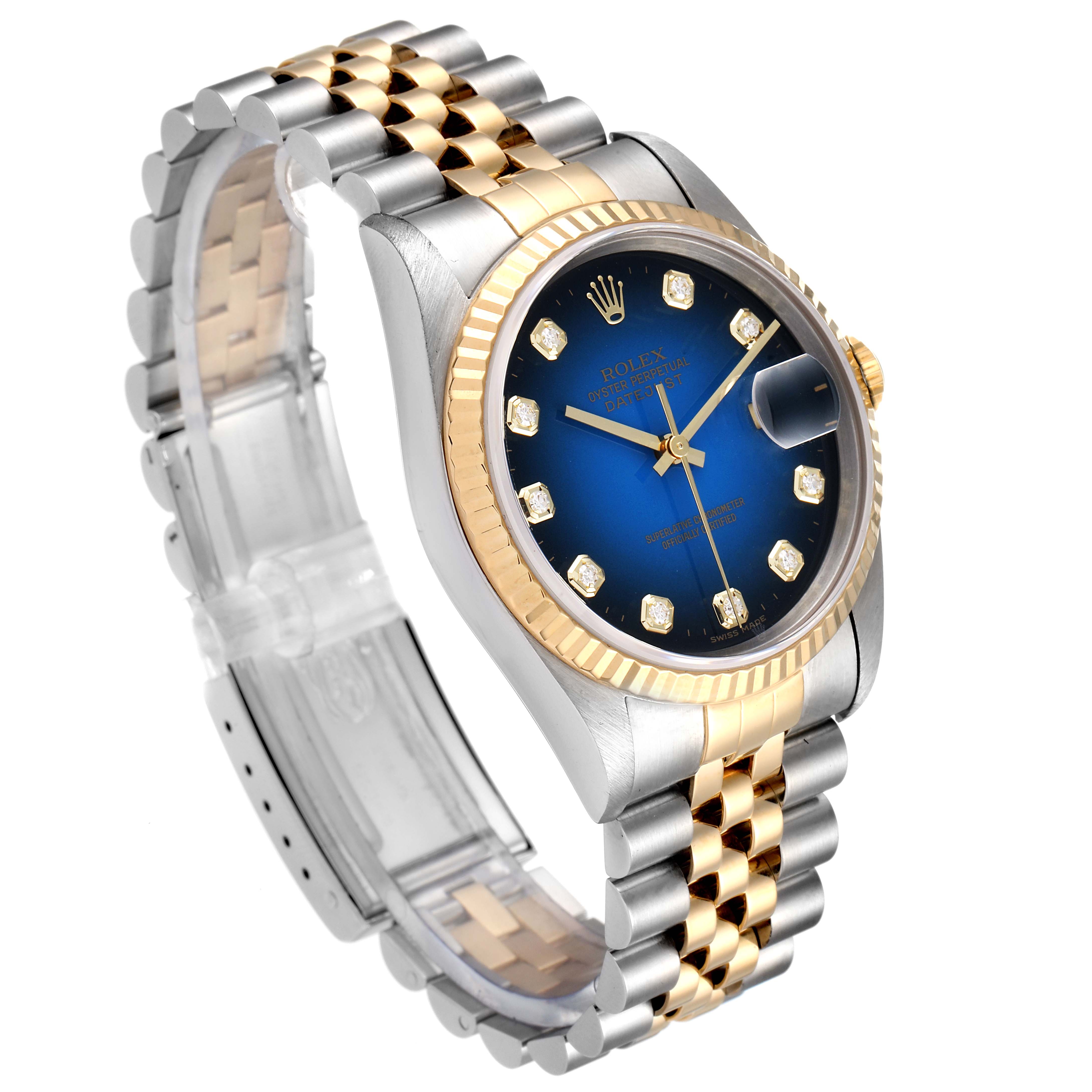 The Rolex Datejust 16233 Men's Steel and Gold (two tone) Blue Dial 16233 Men's Steel and Gold (two tone) Blue Dial watch is shown from an angled side view, highlighting its blue dial, gold bezel, and two-tone bracelet.