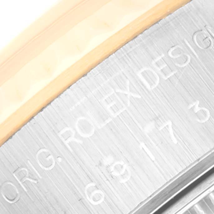 The image shows a close-up of the engraved text "ORIG. ROLEX DESIGN" on the side of a Rolex Datejust 69173 Women's Steel and Gold (two tone) White Dial 69173 Women's Steel and Gold (two tone) White Dial watch.