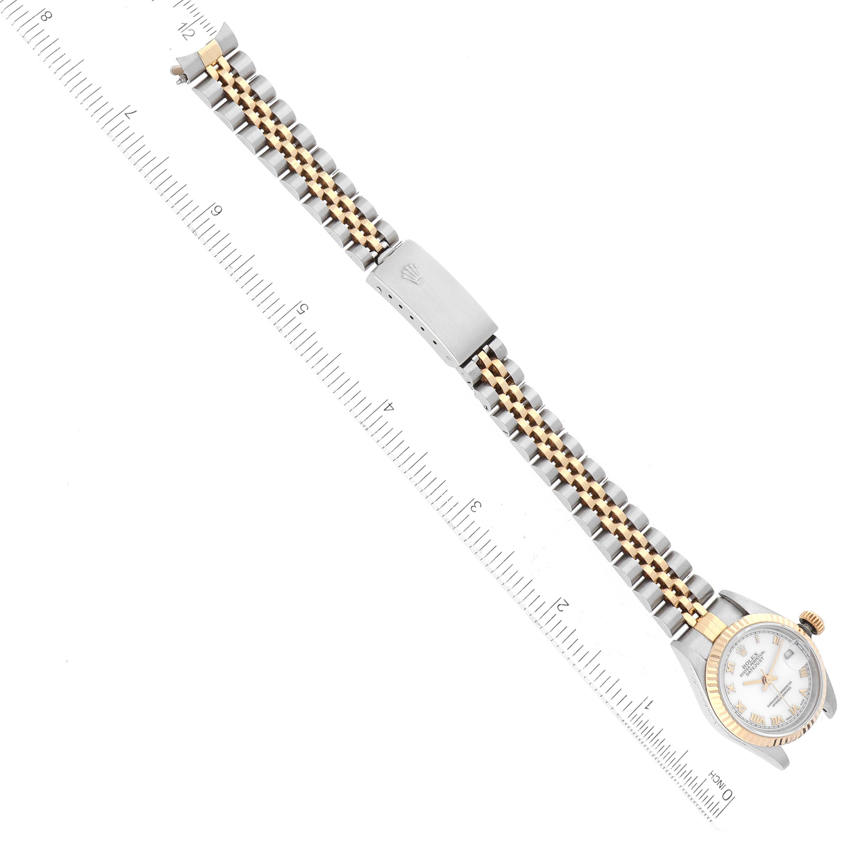 This image shows a top view of a Rolex Datejust 69173 Women's Steel and Gold (two tone) White Dial 69173 Women's Steel and Gold (two tone) White Dial watch, highlighting its face, clasp, and two-tone bracelet aligned with a ruler.