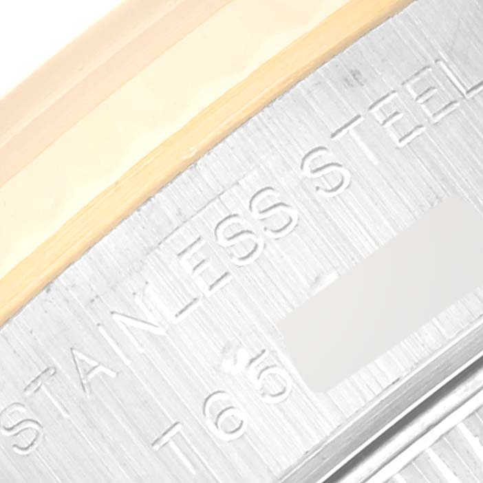 This close-up image shows the side of a Rolex Datejust 69173 Women's Steel and Gold (two tone) White Dial 69173 Women's Steel and Gold (two tone) White Dial with "STAINLESS STEEL" engraved on the caseback.