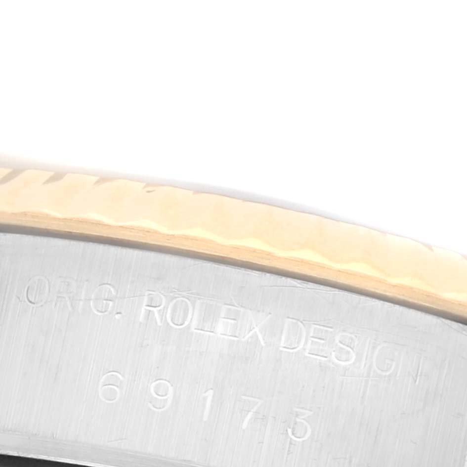 The image shows an angled close-up of the bezel and side of the Rolex Datejust 69173 Women's Steel and Gold (two tone) White Dial 69173 Women's Steel and Gold (two tone) White Dial watch, highlighting engraved details.