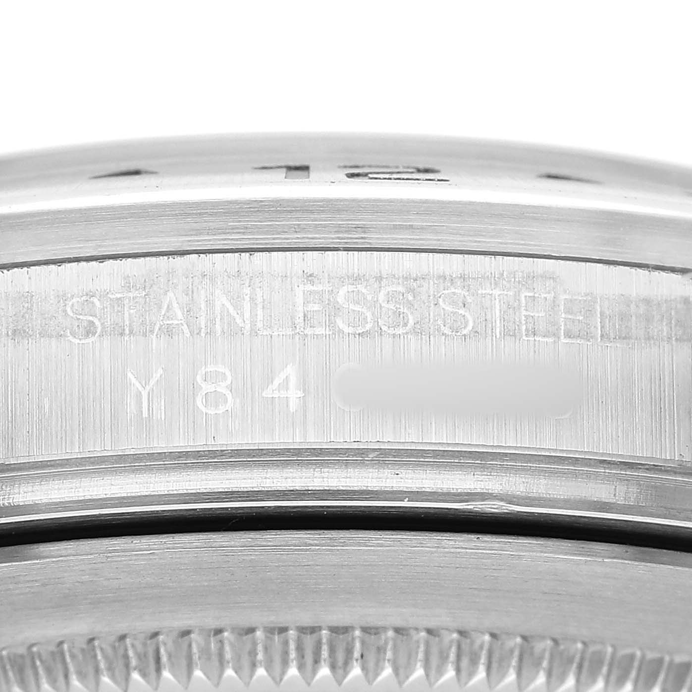 The image shows a close-up of the side of a Rolex Explorer 16570 Men's Stainless Steel White Dial, highlighting its stainless steel engraving.