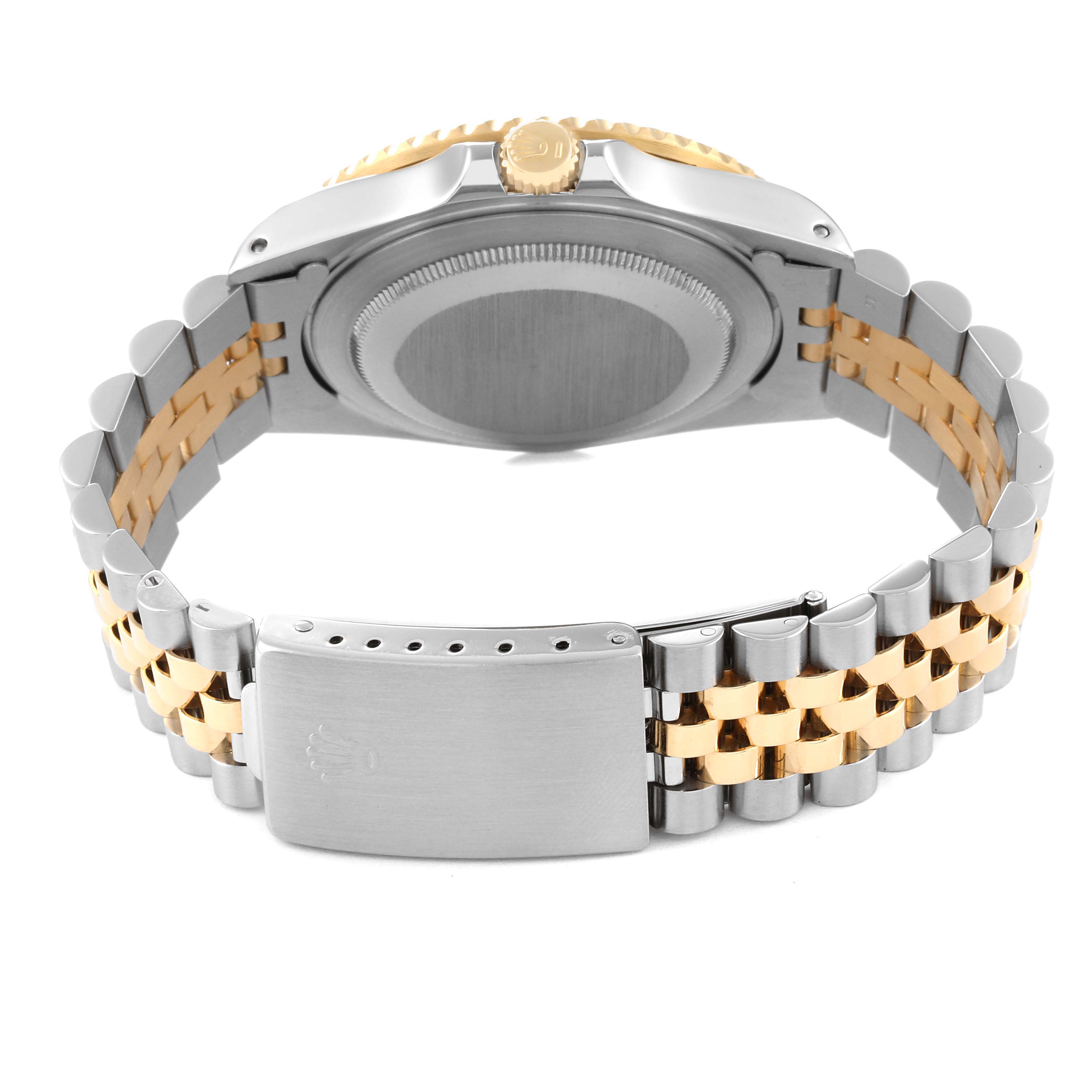 This image shows the backside of the Rolex GMT-Master 16713 Men's Steel and Gold (two tone) Black Dial 16713 Men's Steel and Gold (two tone) Black Dial, highlighting the case back, crown, and two-tone bracelet with clasp.