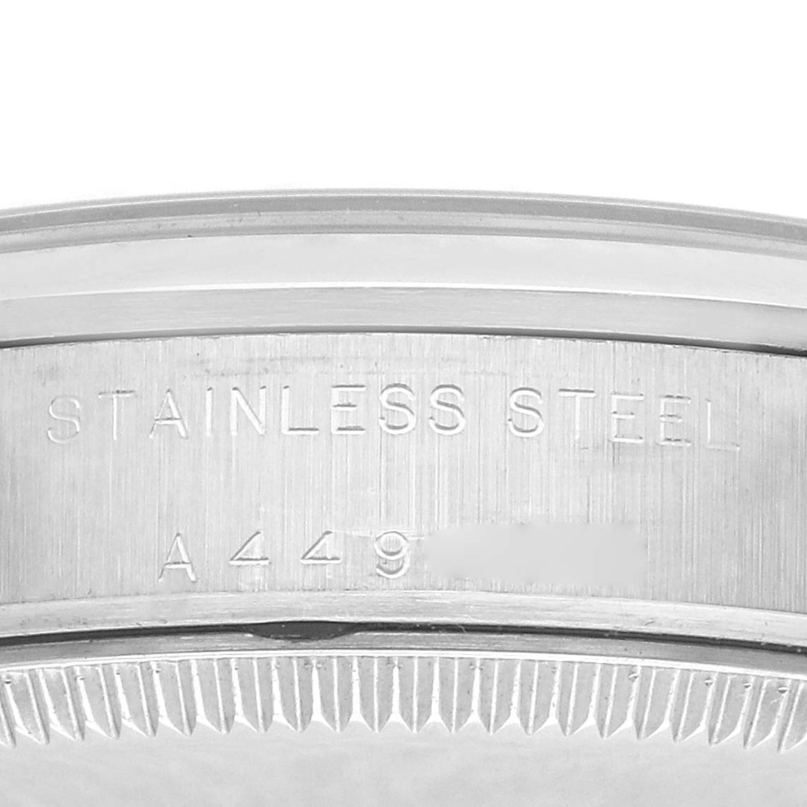 The image shows a close-up of the edge and side of a stainless steel bezel on a Rolex Mid-Size 77080 Women's Stainless Steel Black Dial 77080 Women's Stainless Steel Black Dial model watch.