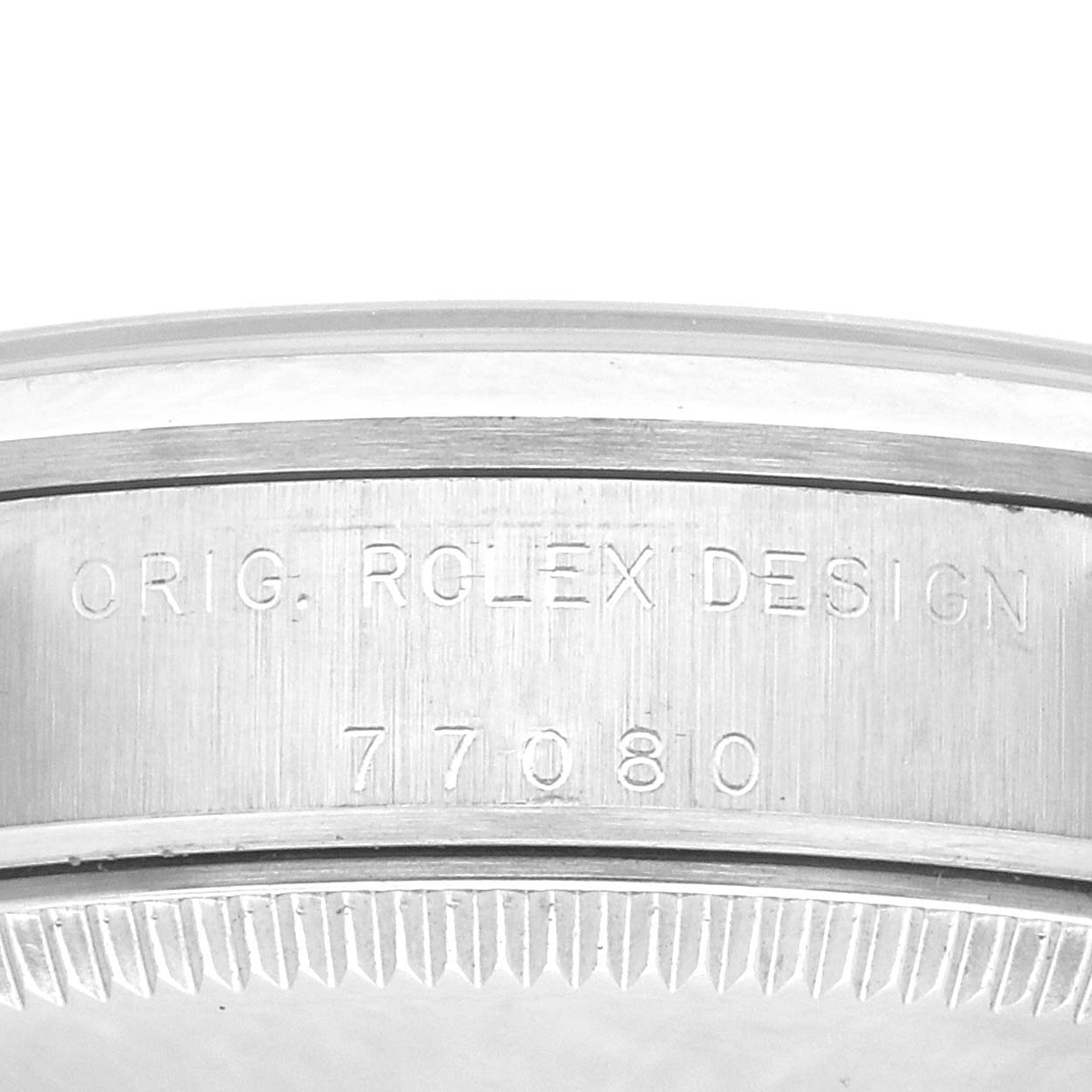 The image shows a close-up of the case side engraving on a Rolex Mid-Size 77080 Women's Stainless Steel Black Dial 77080 Women's Stainless Steel Black Dial watch, highlighting "ORIG. ROLEX DESIGN" and the model number.