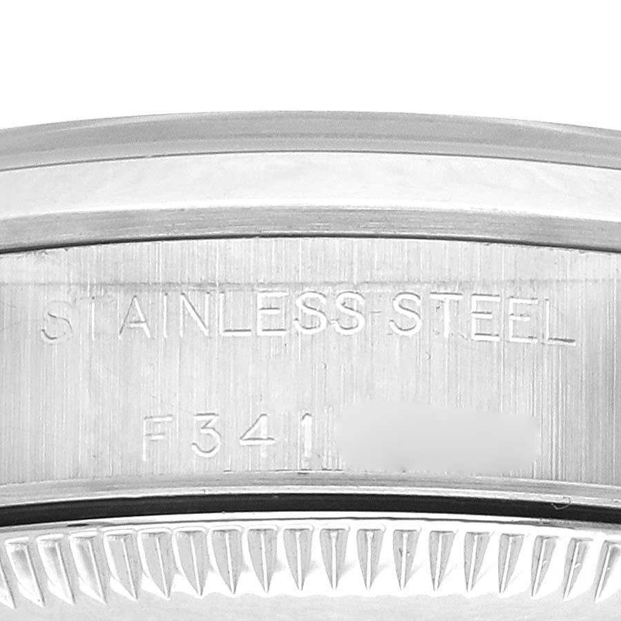 The image shows a close-up of the side engraving on the case back of a Rolex Oyster Perpetual 76080 Women's Stainless Steel Black Dial 76080 Women's Stainless Steel Black Dial watch, highlighting "STAINLESS STEEL".