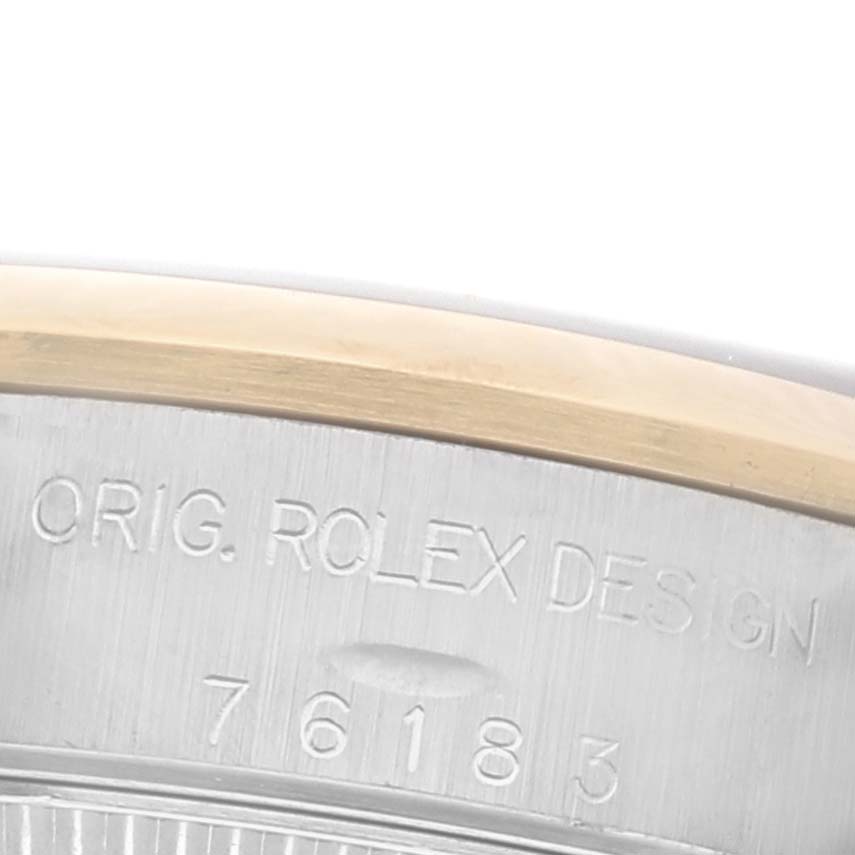The image shows the engraved inner bezel of a Rolex Datejust 76183 Women's Steel and Gold (two tone) Black Dial 76183 Women's Steel and Gold (two tone) Black Dial watch, highlighting branding and serial number details.