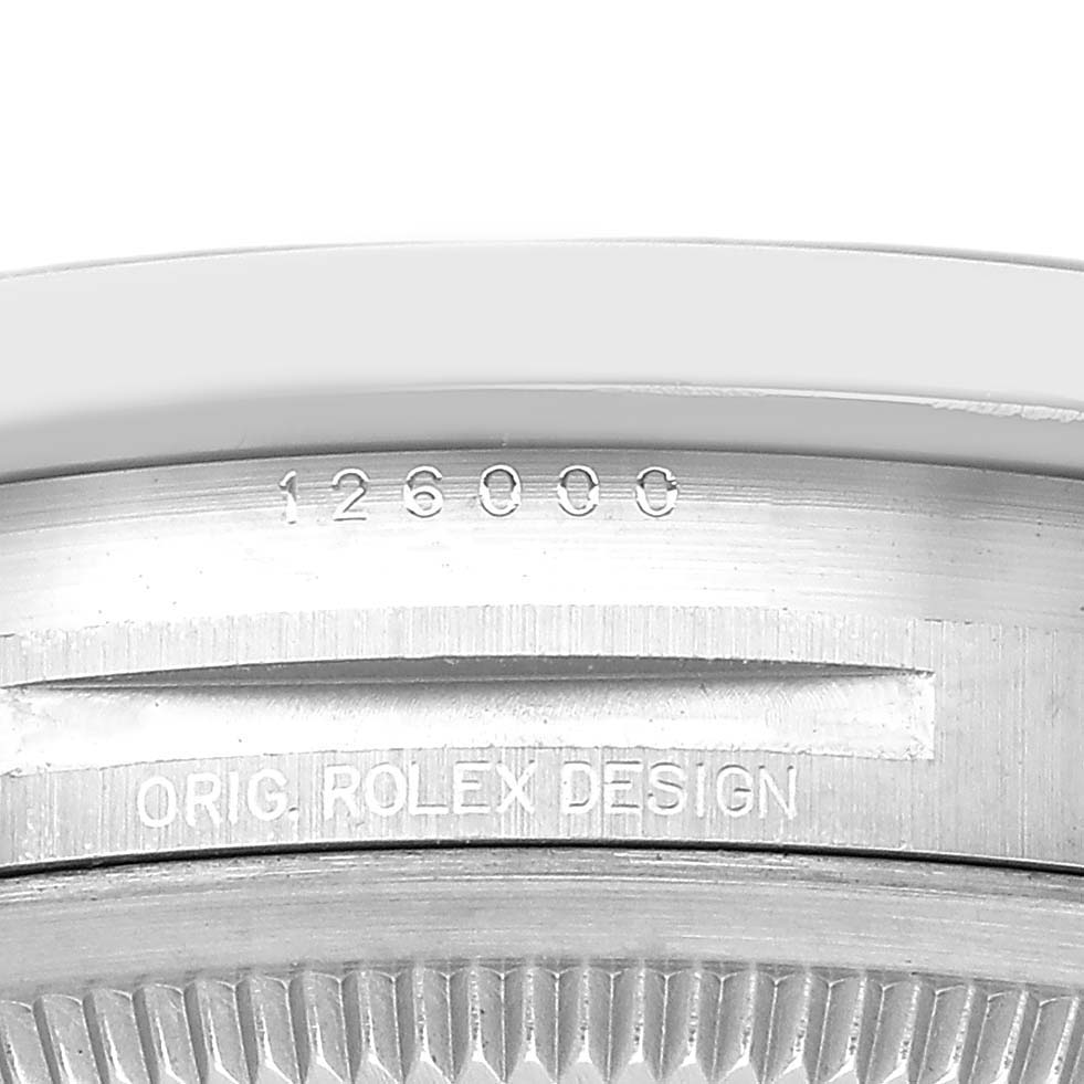 The image shows a close-up of the case back of a Rolex Oyster Perpetual 126000 Men's Stainless Steel Black Dial, highlighting the model number and "Orig. Rolex Design."