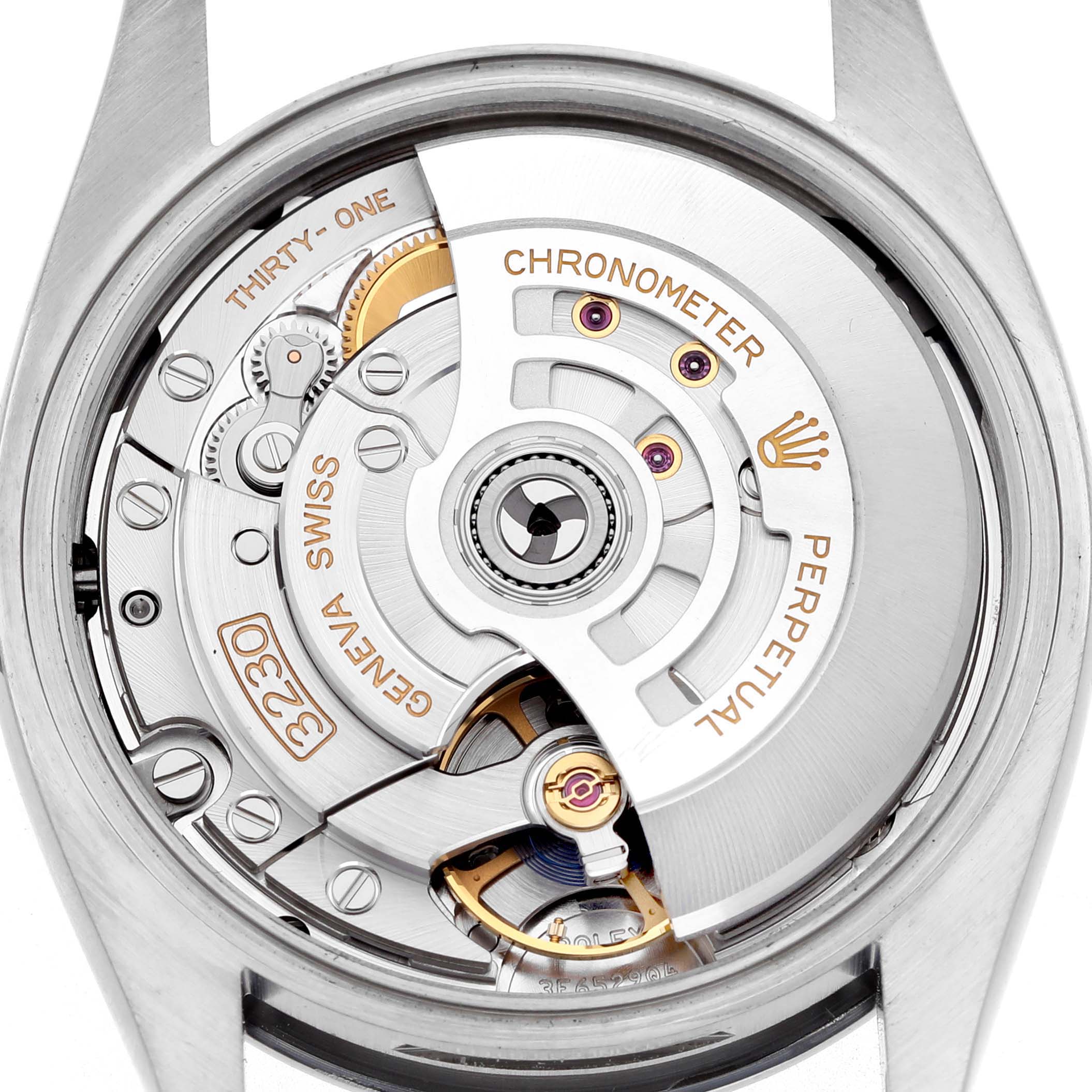 The image shows the back view of a Rolex Oyster Perpetual 126000 Men's Stainless Steel Black Dial, highlighting its intricate movement and chronometer details.