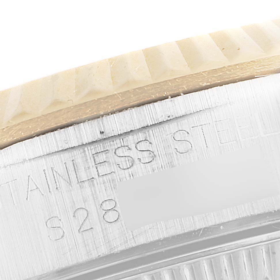 This close-up image shows part of the bezel and engraved serial number on a Rolex Oyster Perpetual 67193 Women's Steel and Gold (two tone) White Dial 67193 Women's Steel and Gold (two tone) White Dial watch.