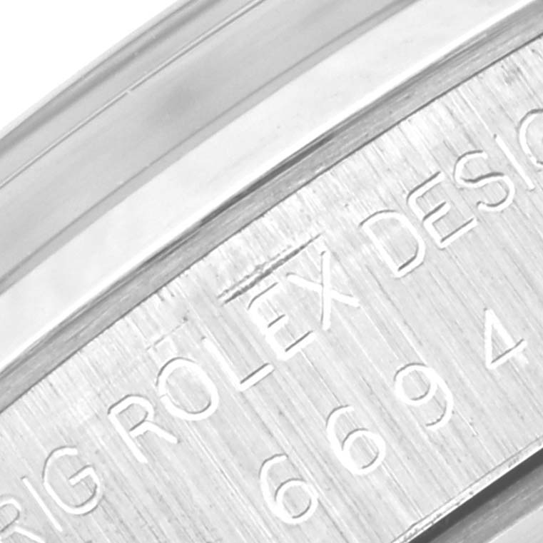 This close-up shows the engraved case back and serial number of a Vintage Collection Rolex watch.