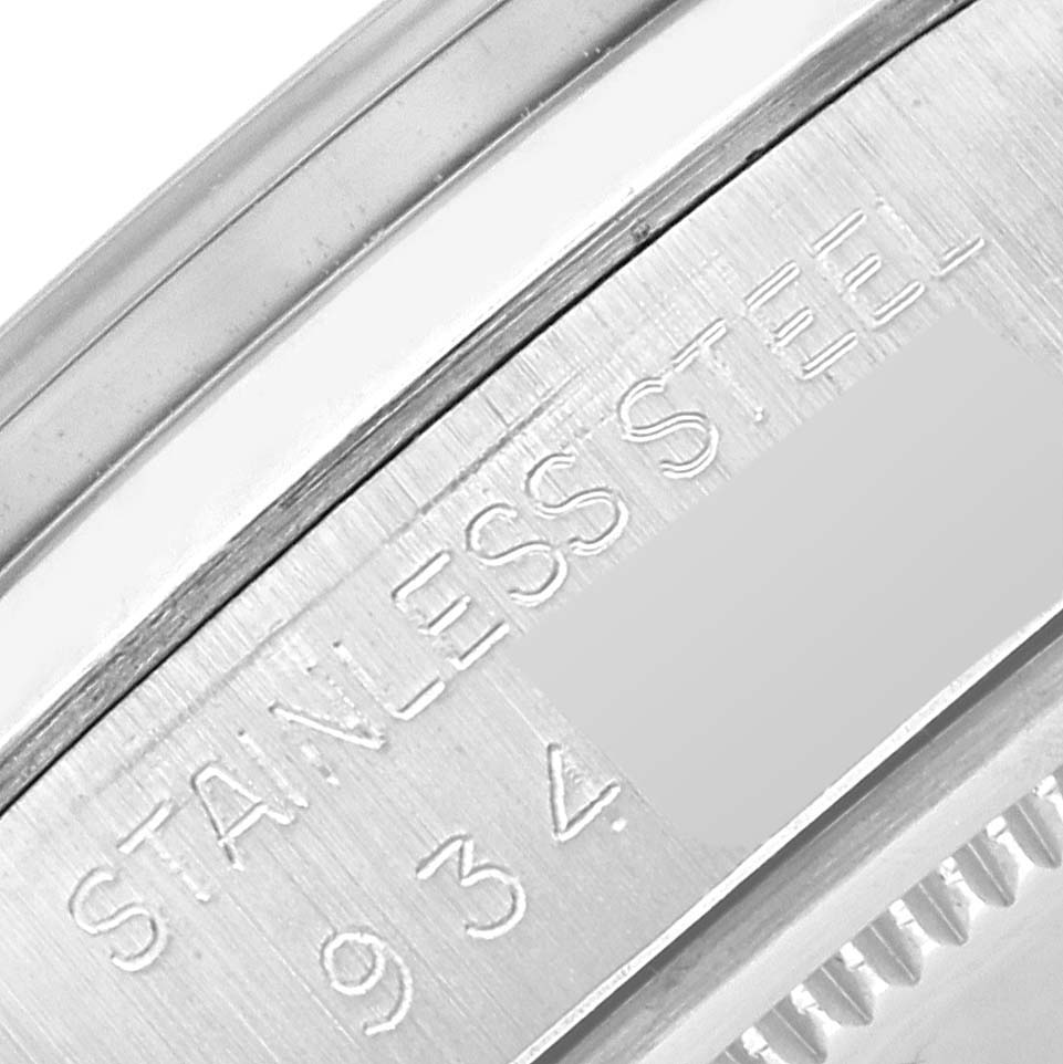This image shows a close-up of the stainless steel casing of the Rolex Vintage Collection 6694 Men's Stainless Steel Silver Dial 6694 Men's Stainless Steel Silver Dial watch, focusing on engraved details.