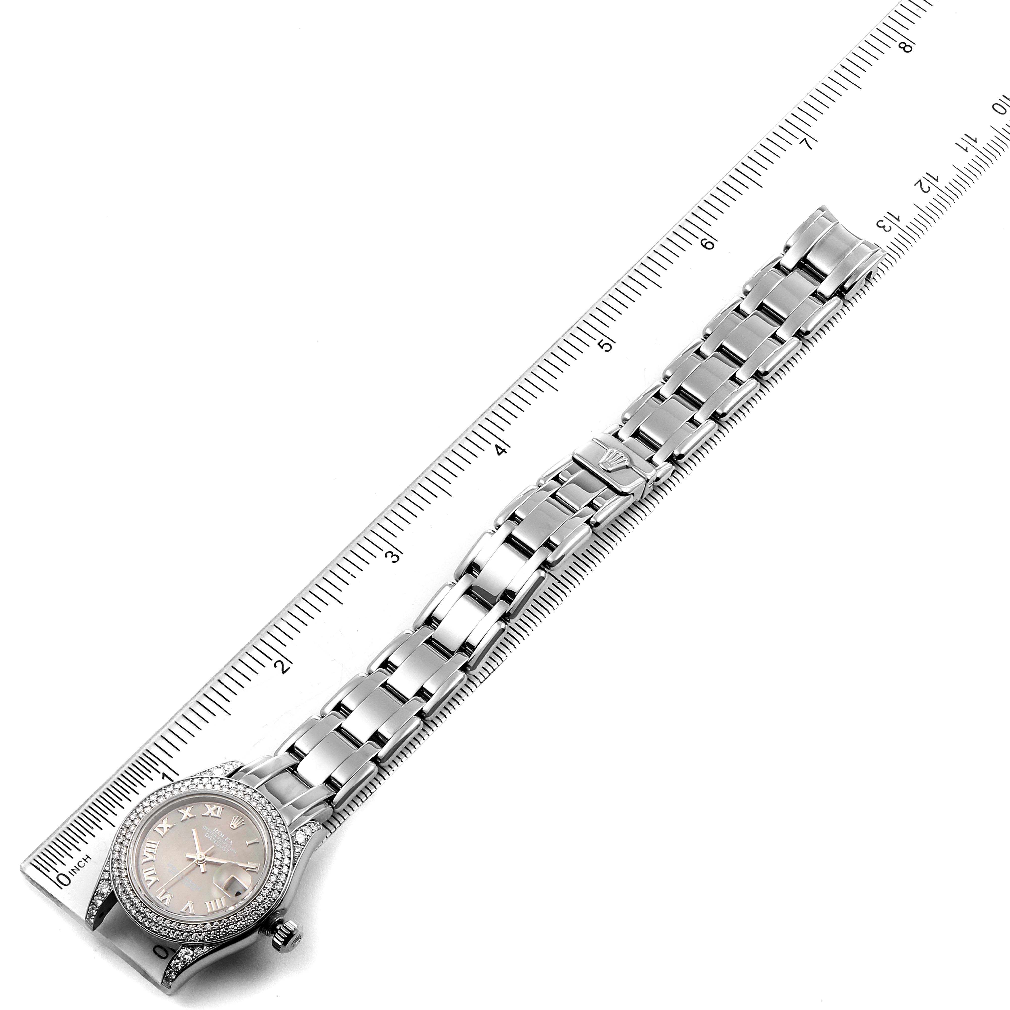 The image shows a Rolex Pearlmaster 69359 Women's White Gold Mother of Pearl Dial 69359 Women's White Gold Mother of Pearl Dial watch laid flat next to a ruler, highlighting its face, bezel, and fully extended bracelet.