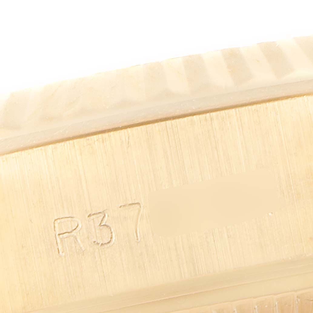 This image shows a close-up of the engraved serial number on the case of a Rolex President 69178 Women
s Yellow Gold Champagne Dial 69178 Women
s Yellow Gold Champagne Dial model watch.