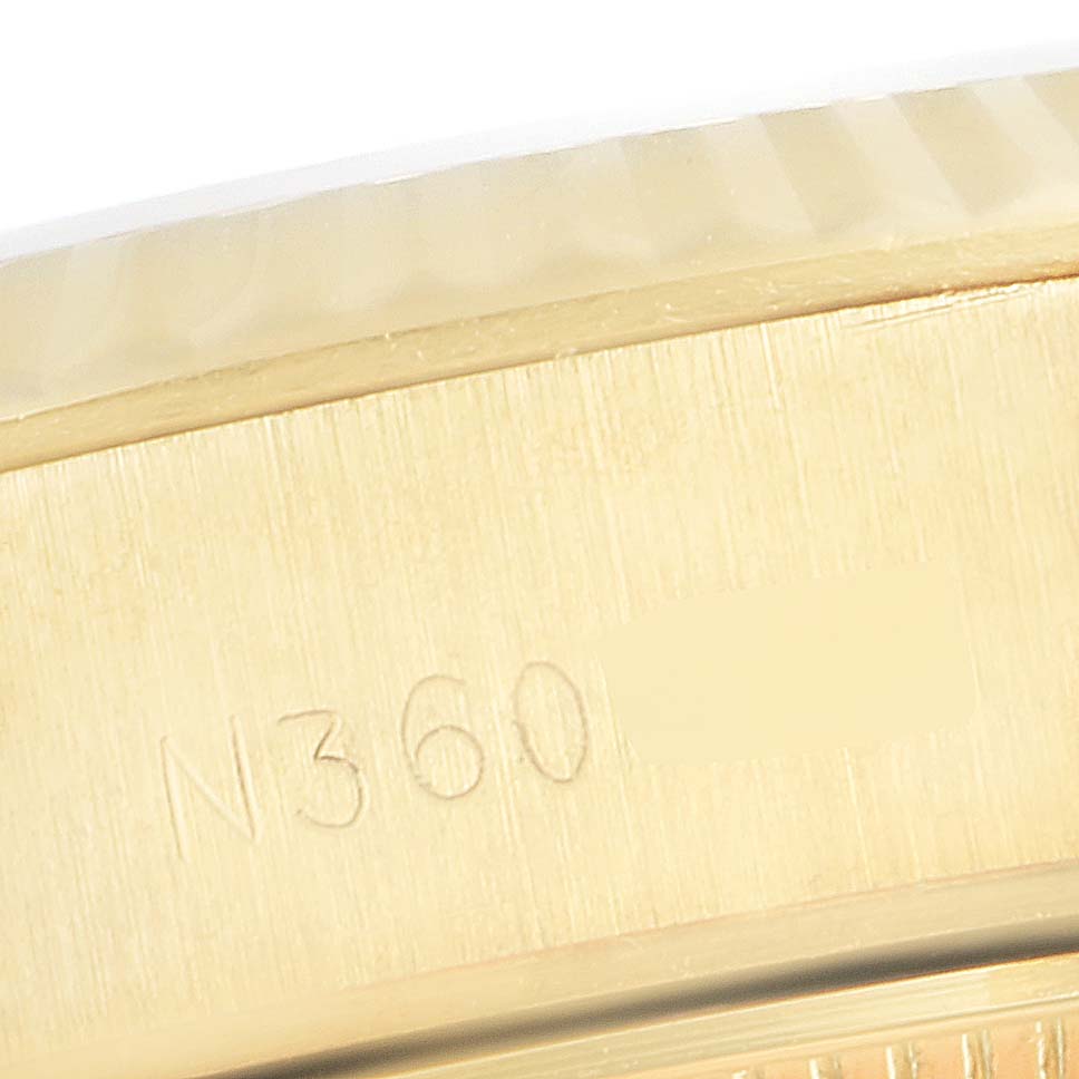 The image shows an extreme close-up of the side of a Rolex President 69178 Women
s Yellow Gold Champagne Dial 69178 Women
s Yellow Gold Champagne Dial model watch, highlighting the engraved serial number.