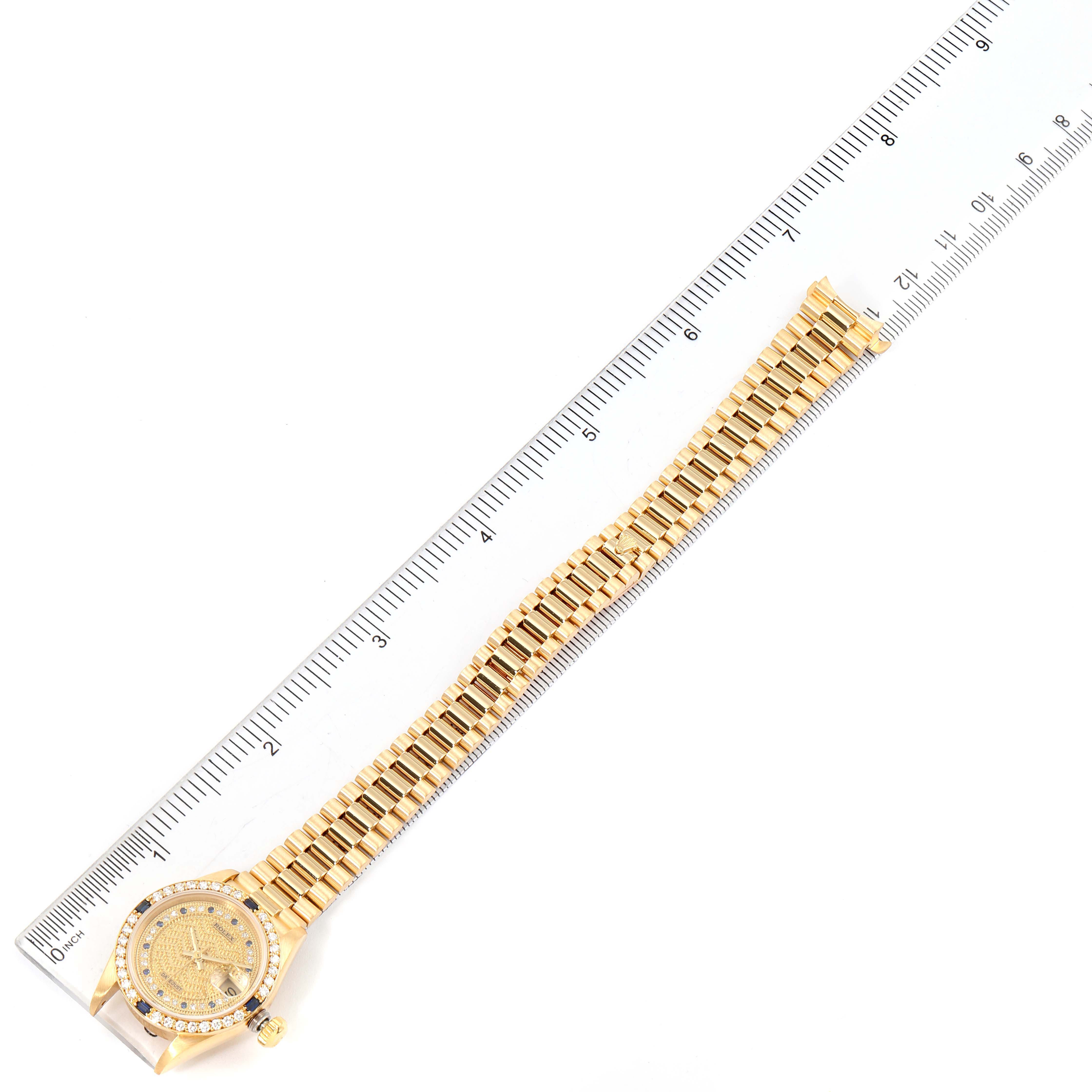 The image shows a full-length view of the Rolex President 69088 Women's Yellow Gold Champagne Dial 69088 Women's Yellow Gold Champagne Dial watch placed alongside a ruler.