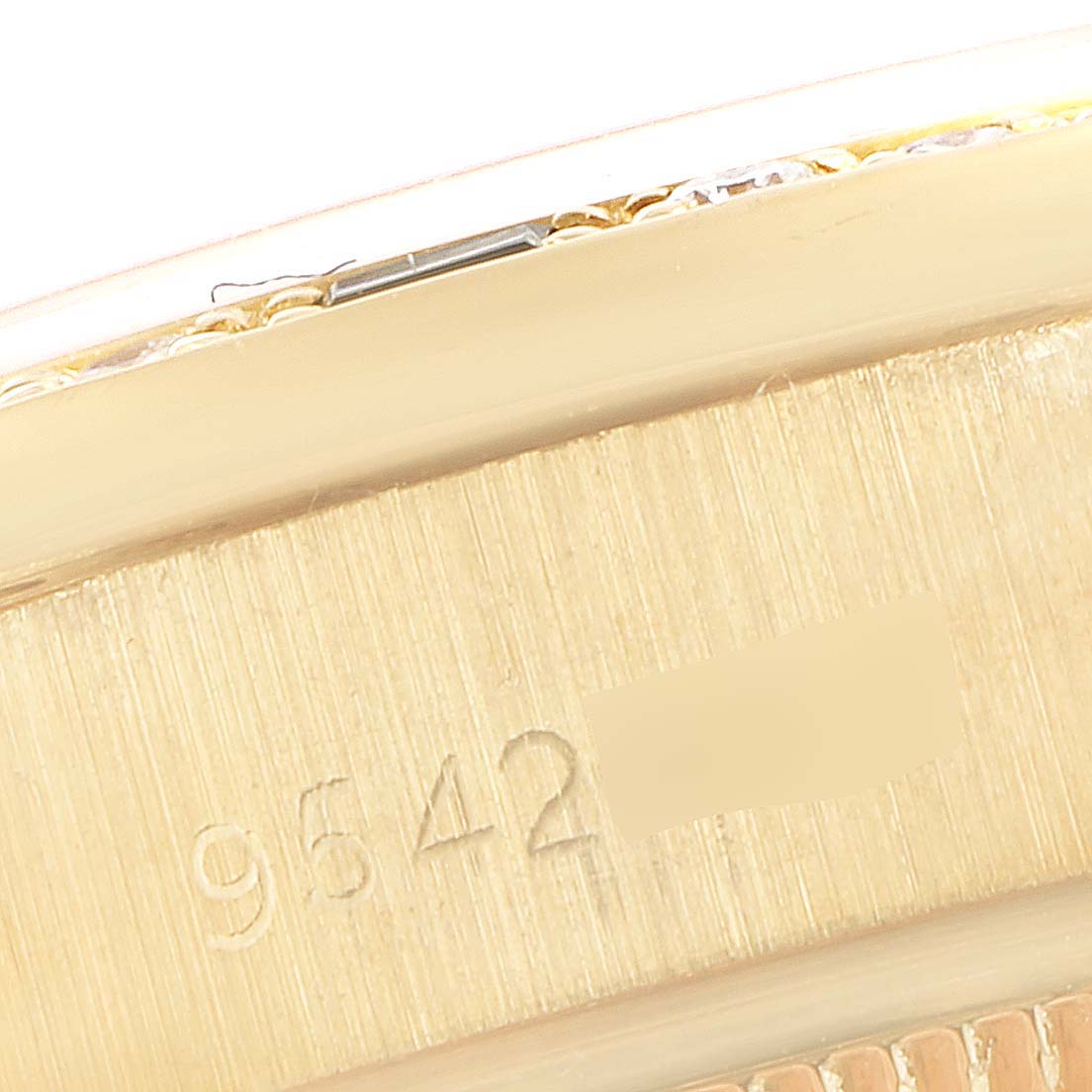 This image shows a close-up of the side and serial number of a Rolex President 69088 Women's Yellow Gold Champagne Dial 69088 Women's Yellow Gold Champagne Dial model watch.